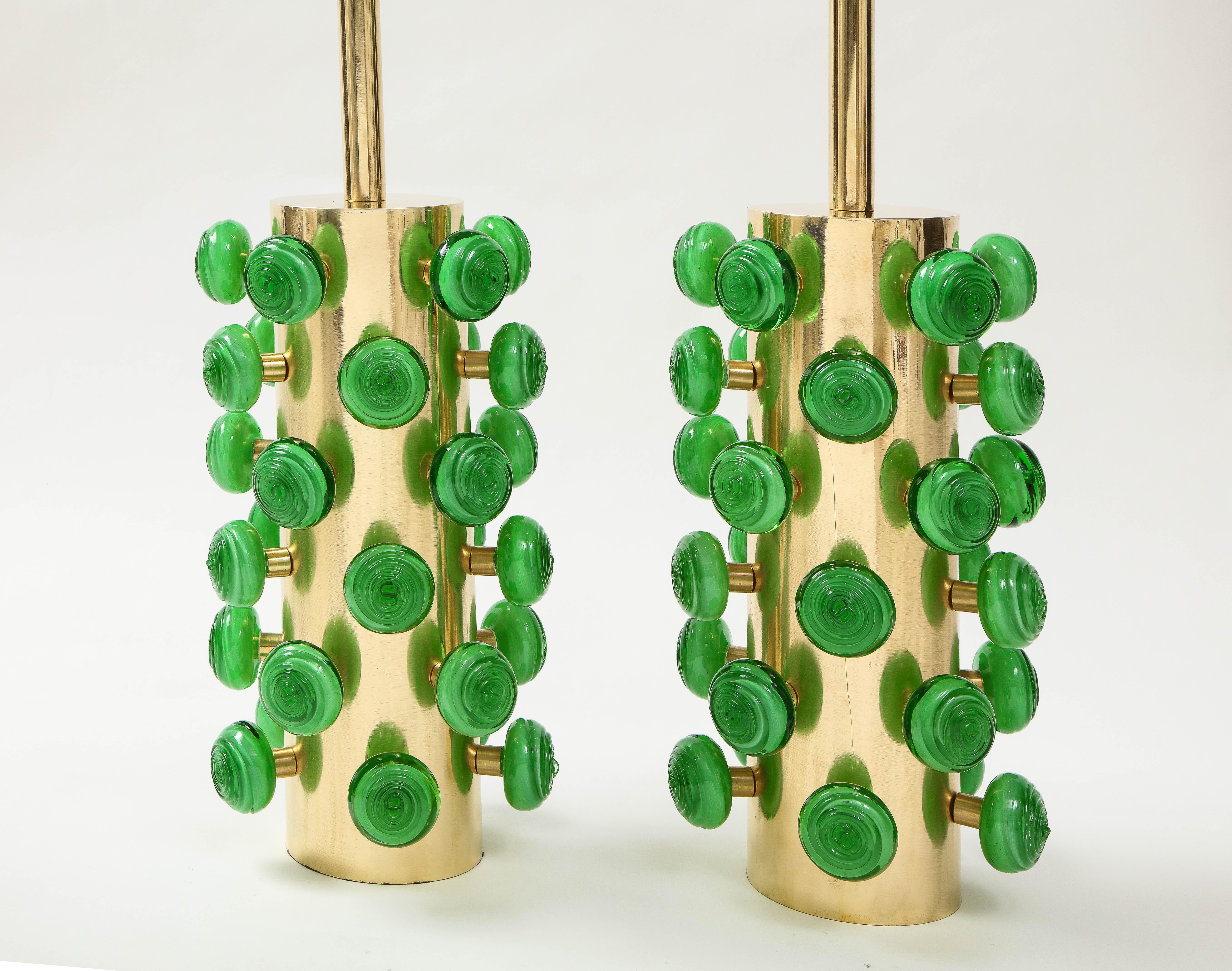 One of a kind pair of tall sculptural brass cylinder lamps with kelly green swirl glass knobs. Hand-casted Kelly green Murano round glass with a swirl texture are screwed on brass stems projecting from the lamp base, thereby creating a 3 dimensional