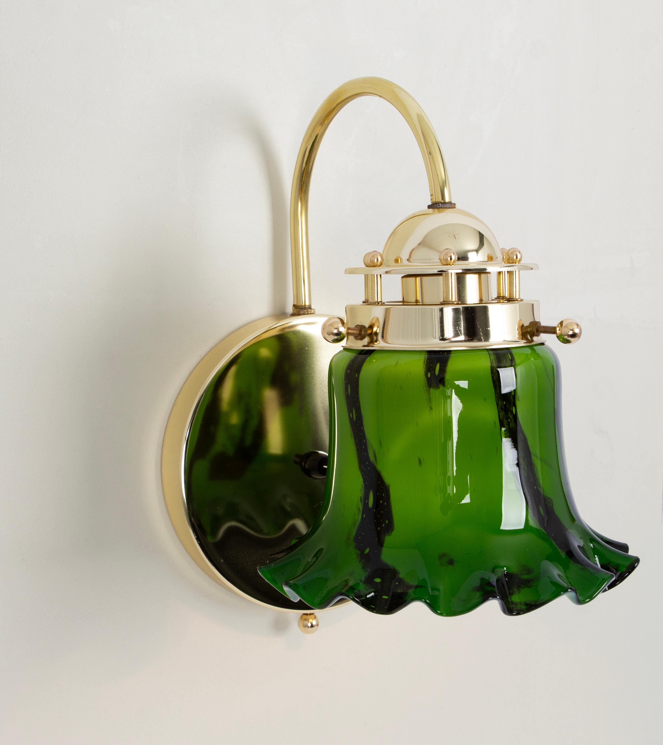 Pair of wall sconces with green opal glasses on a brass frame, made by Peil & Putzler, Germany, 1970s
Wonderful light effect.
High quality and in very good condition. Cleaned, well-wired, and ready to use. 

Each fixture requires 1 x E27 Standard