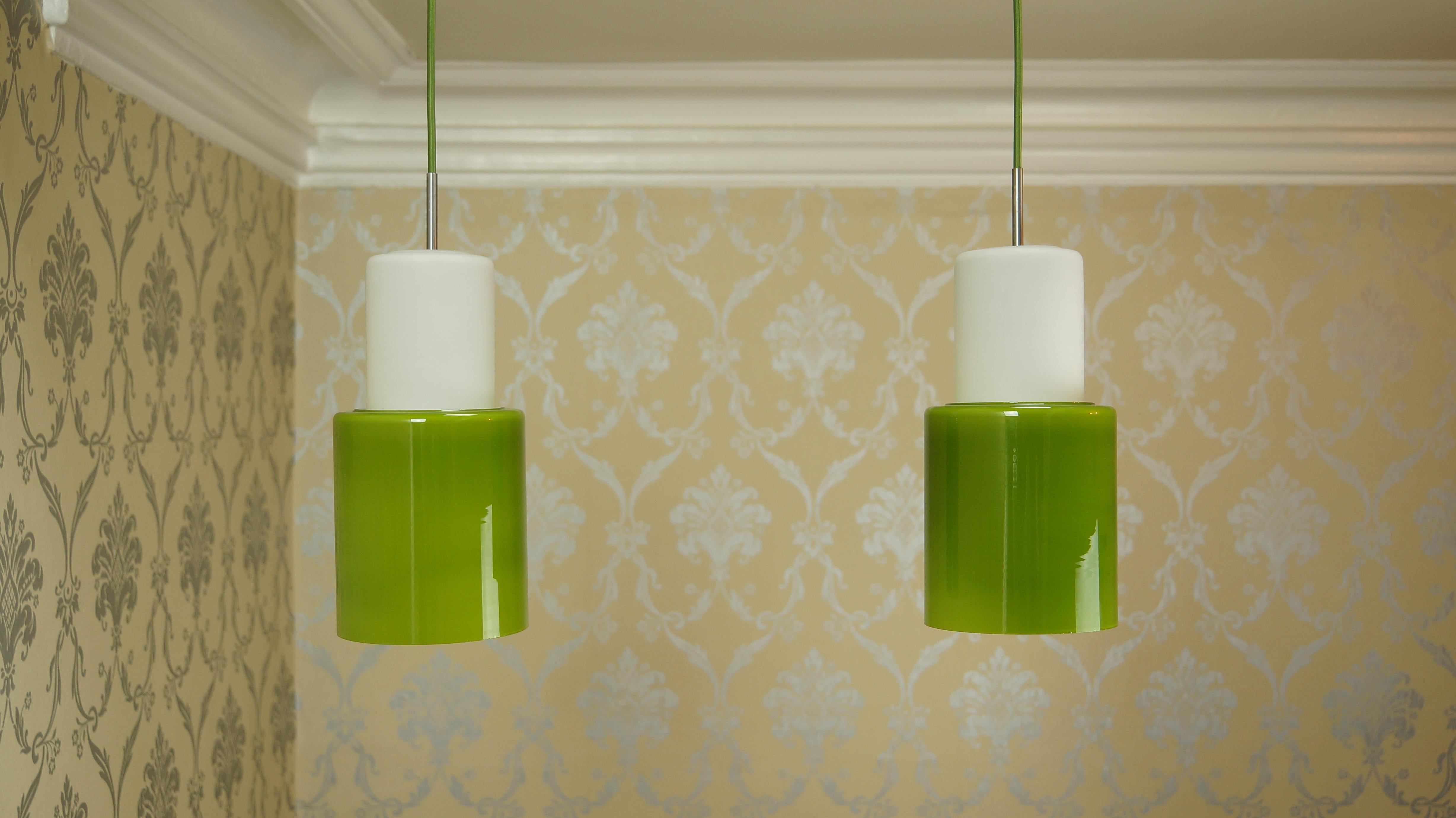 Pair of vintage green and opaline glass Danish ceiling pendant lights, Retro, 1960s, Mid-Century Modern.

An eye-catching pair of Danish pendant lights dating from the 1960s in gorgeous green and white cased glass, opaline glass and a stainless