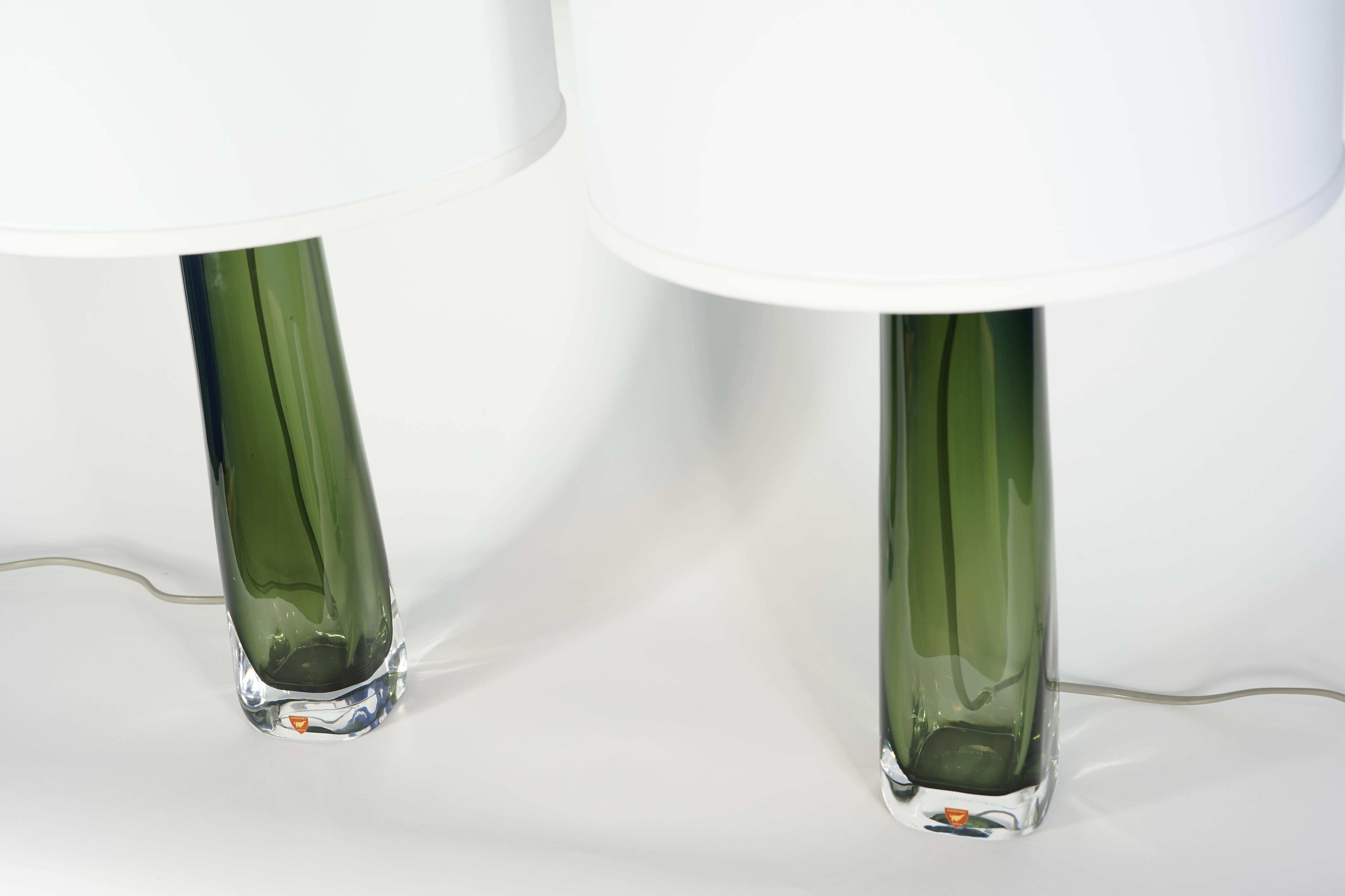 Tall pair of Green Orrefors glass lamps with chrome fittings, signed Carl Fagerlund Orrefors on the bottom
The glass body is 13