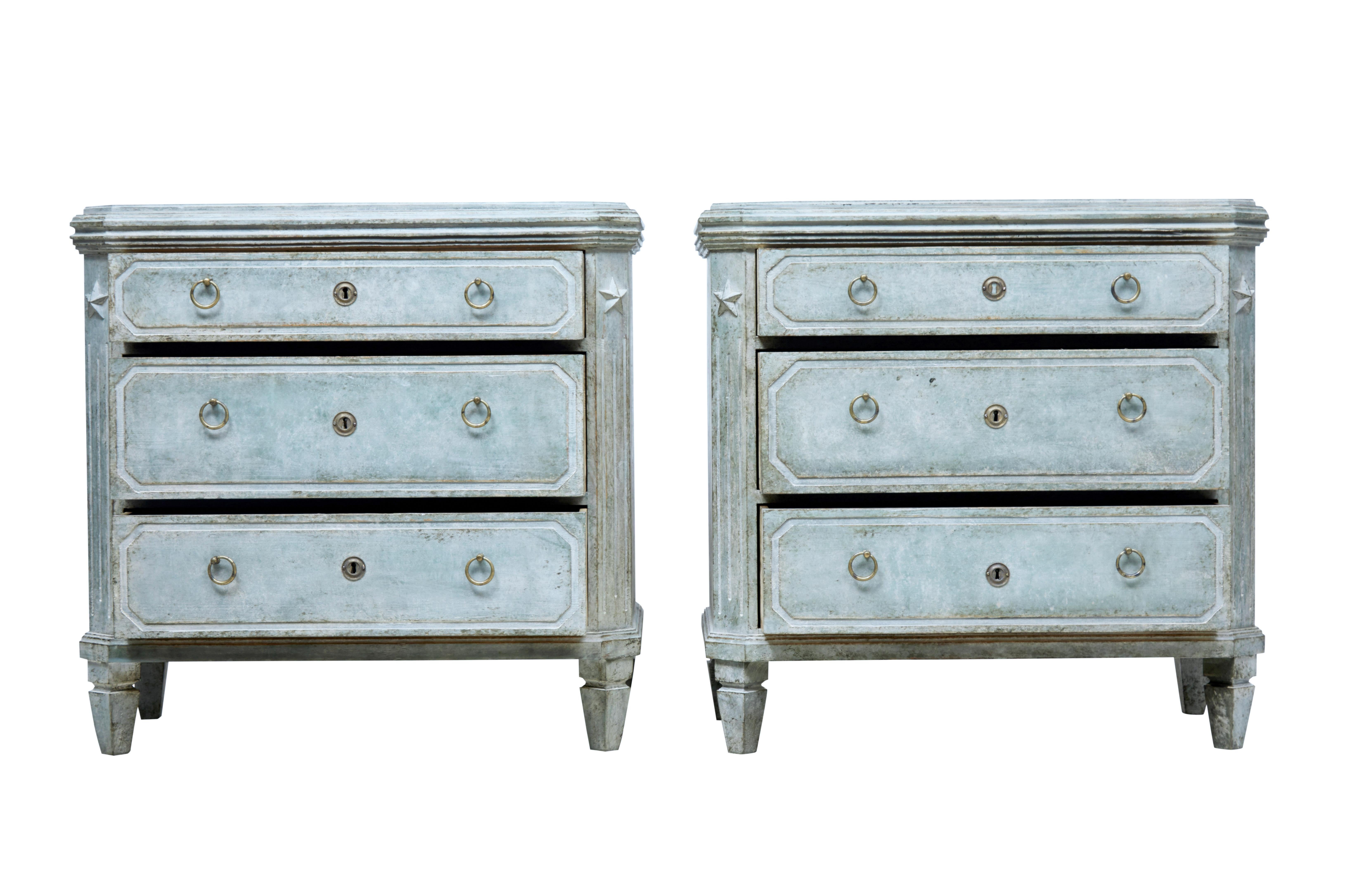 Fine pair of Gustavian style commodes, circa 1870.

3 graduating drawers fitted with simple brass ring handles. Over sailing stepped top surface. Canted corners with fluted detail and applied star motif.

Later green paint which has now taken on