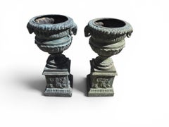 Pair of Green Patinated Bronze Urns with Ram Head Reliefs