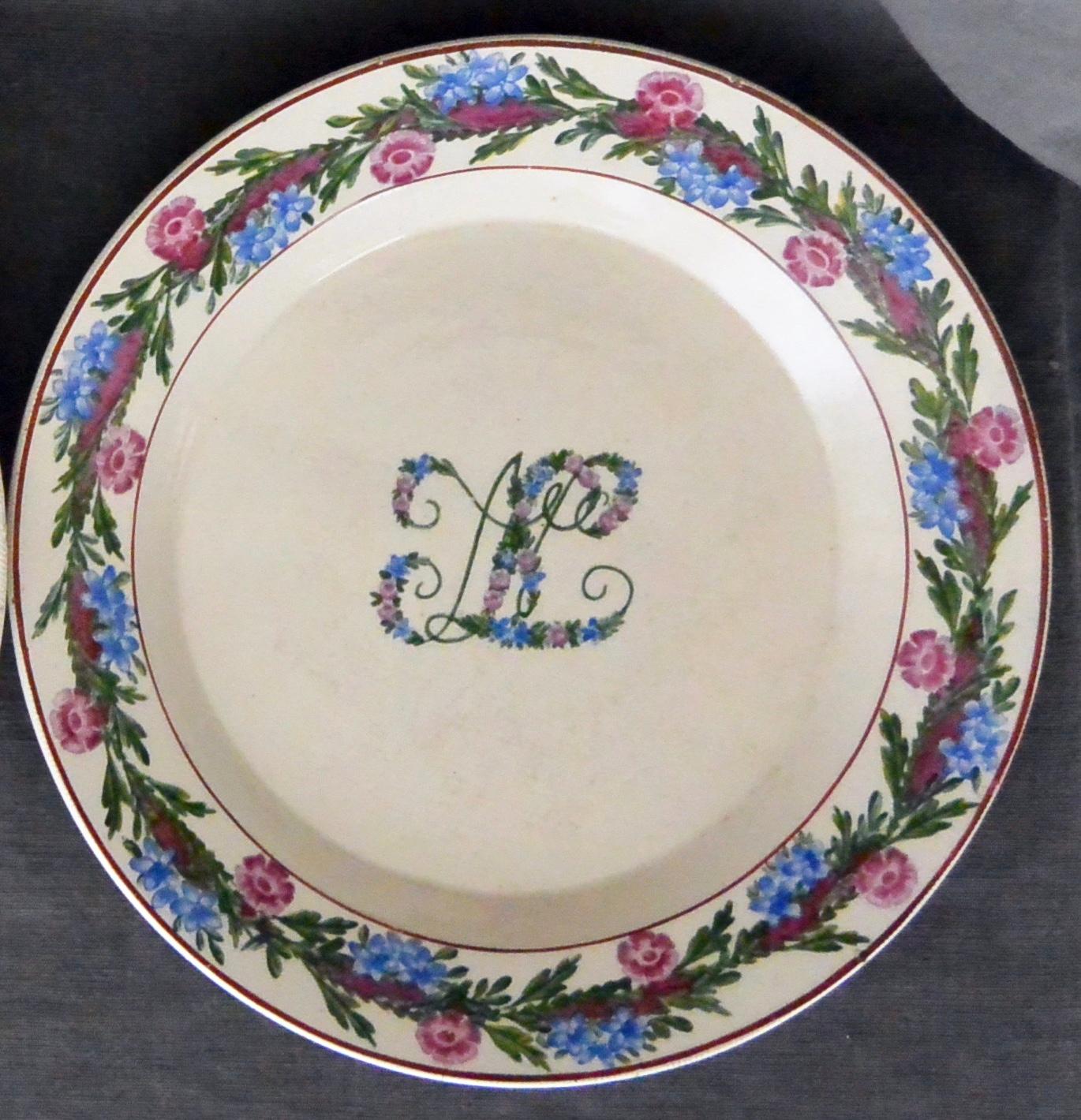 Pair of green, pink and blue floral banded plates. Antique creamware soup and under-plate with jewel-tone floral banding and monogram; with impressed marks for Giustiniani Naples, Italy, late 18th century.
Dimension: Soup plate 9.5' diameter x 1.5