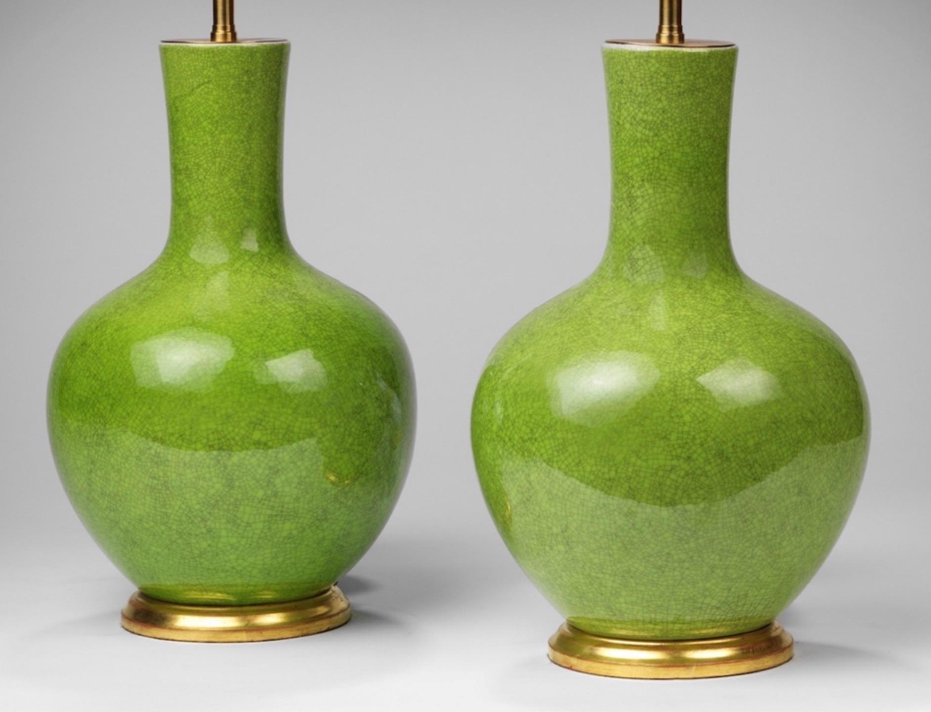 A fine pair of small bright green craquellure straight necked vases, now mounted as a lamps. Ideal for beside tables, or those smaller spaces.

Measures: Height of vases 14 in (36 cm) including the hand gilded bases, but excluding any electrical