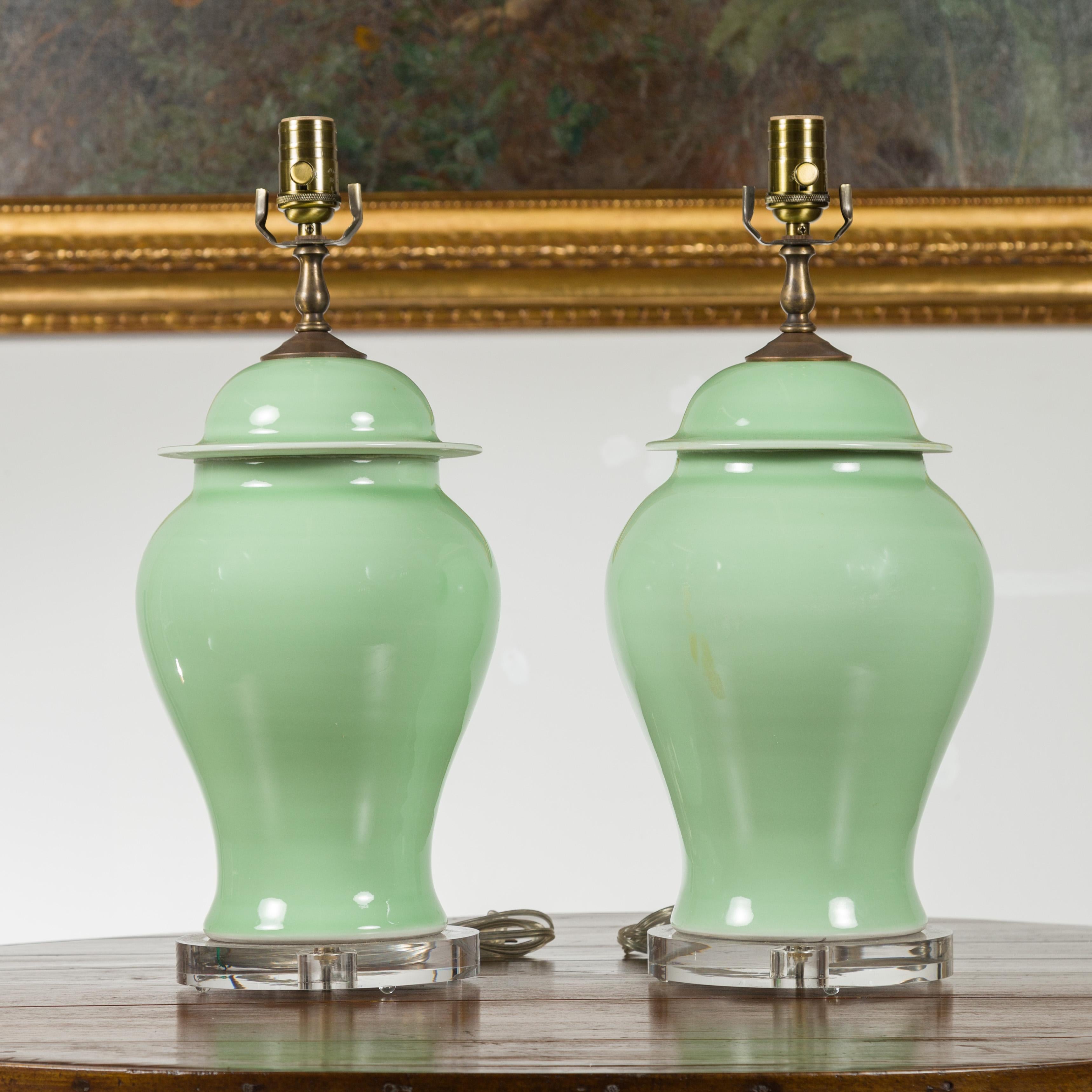 Contemporary Pair of Green Porcelain Lidded Jar Table Lamps with Round Lucite Bases, Wired For Sale