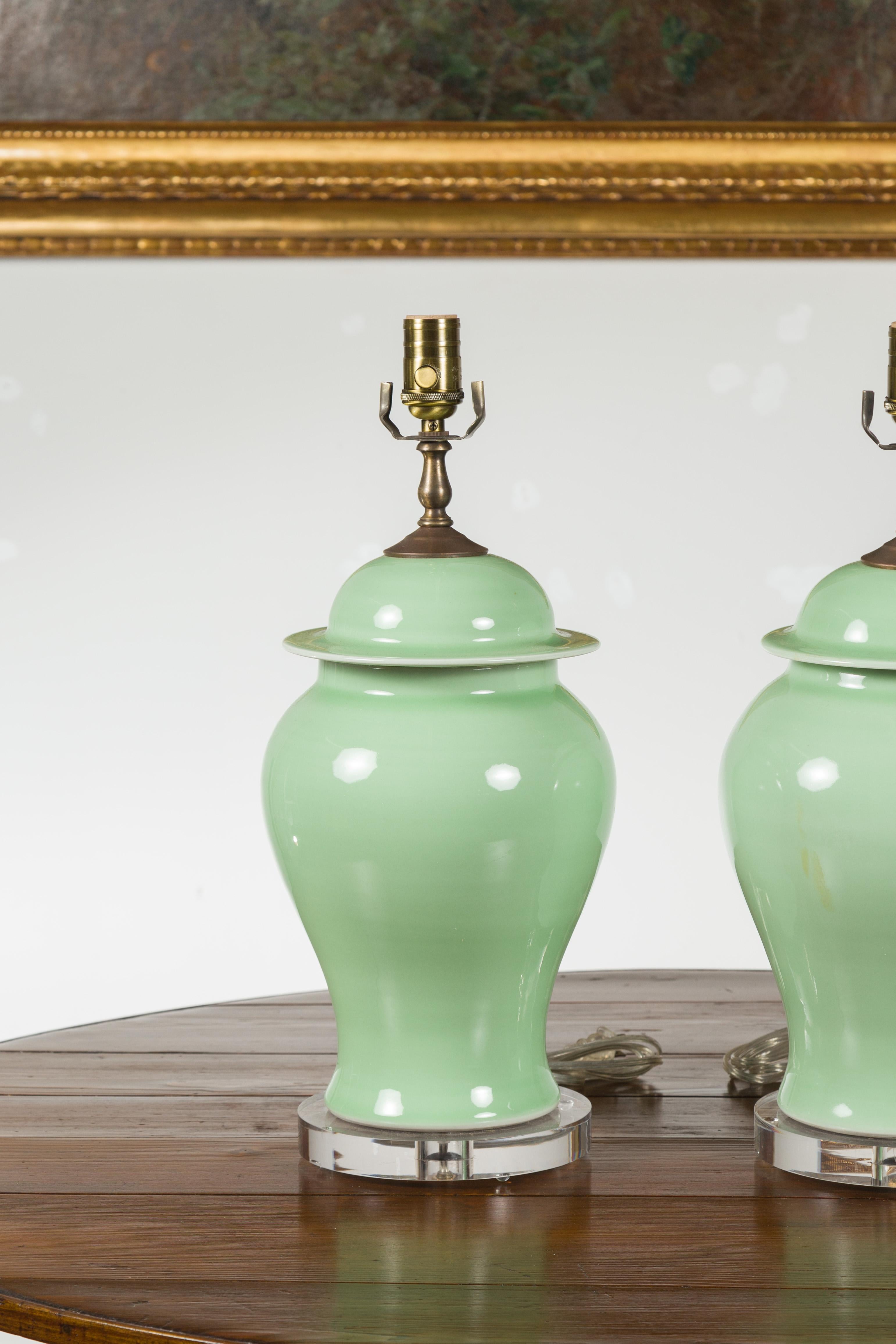 Pair of Green Porcelain Lidded Jar Table Lamps with Round Lucite Bases, Wired For Sale 1