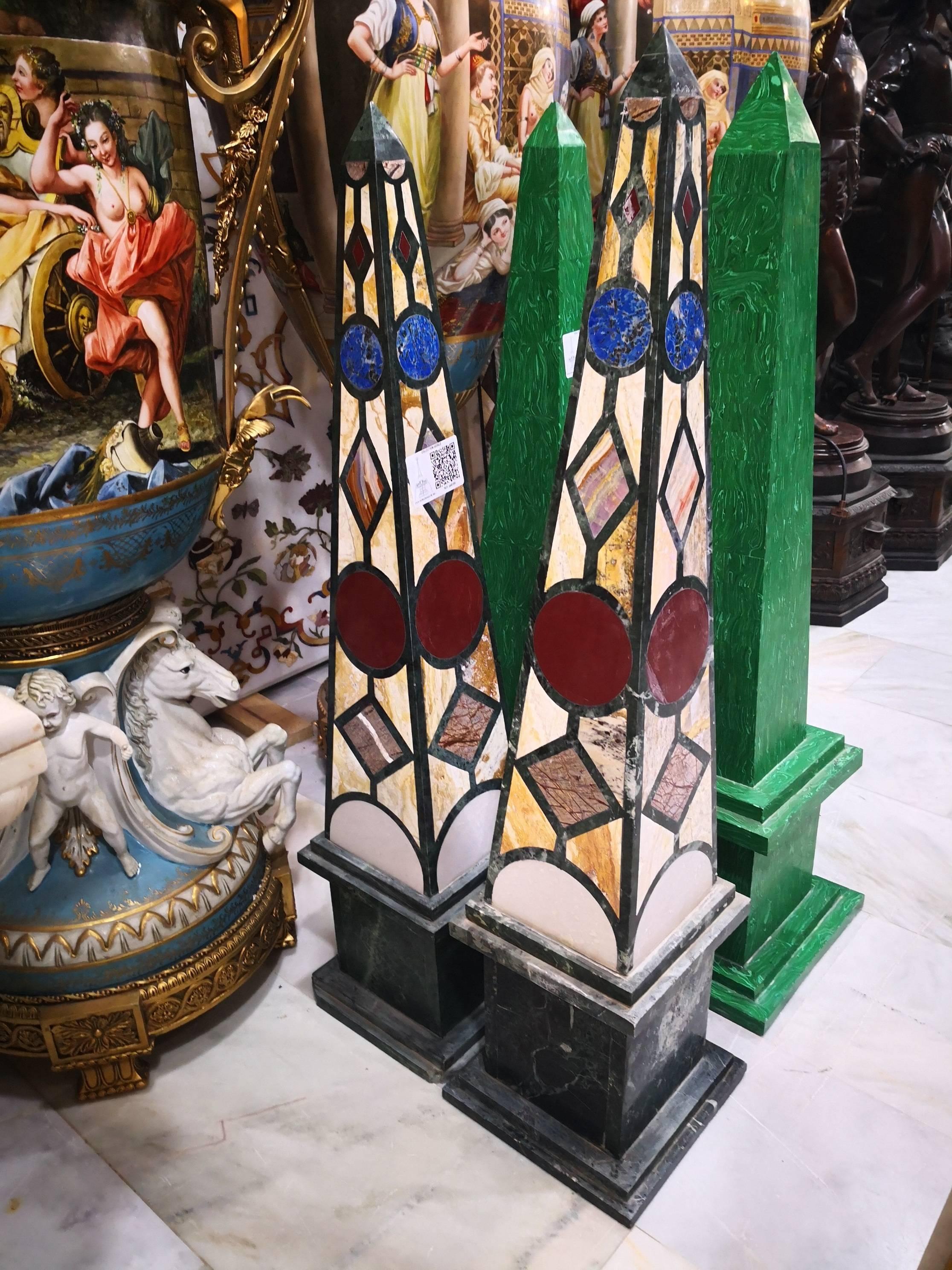 Pair of marble obelisks with a neoclassical geometric mosaic in precious lapis lazuli, different colored marbles and Romano travertine stone.