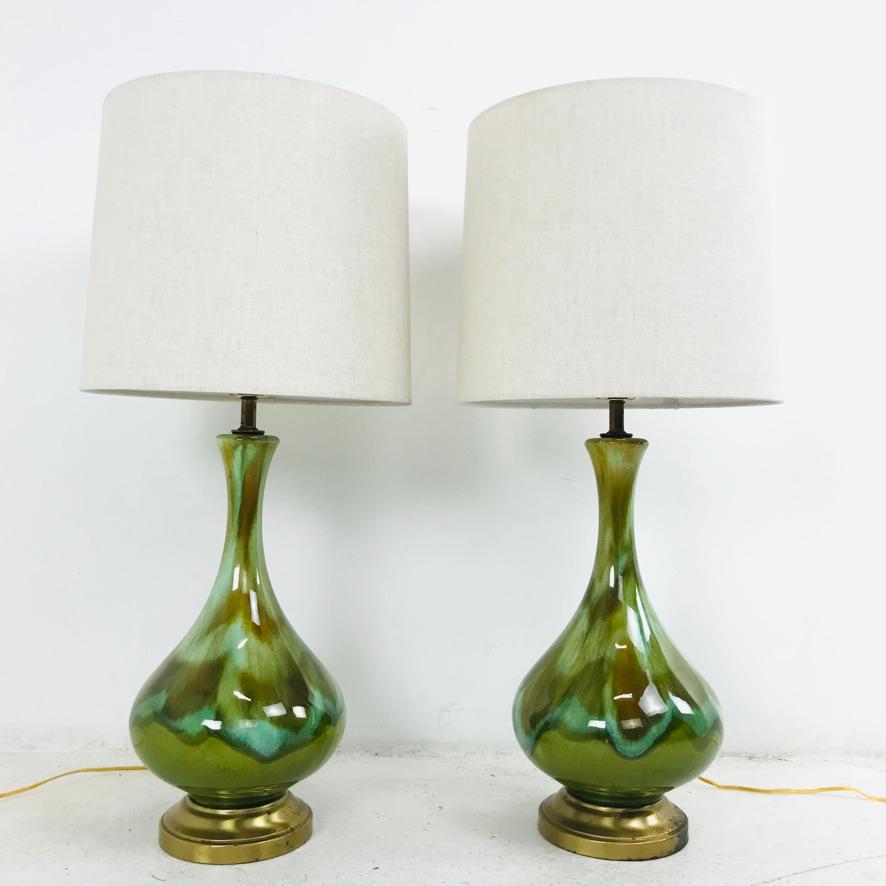 Gorgeous pair of green/multicolored glass table lamps on brass frames. Shades included.