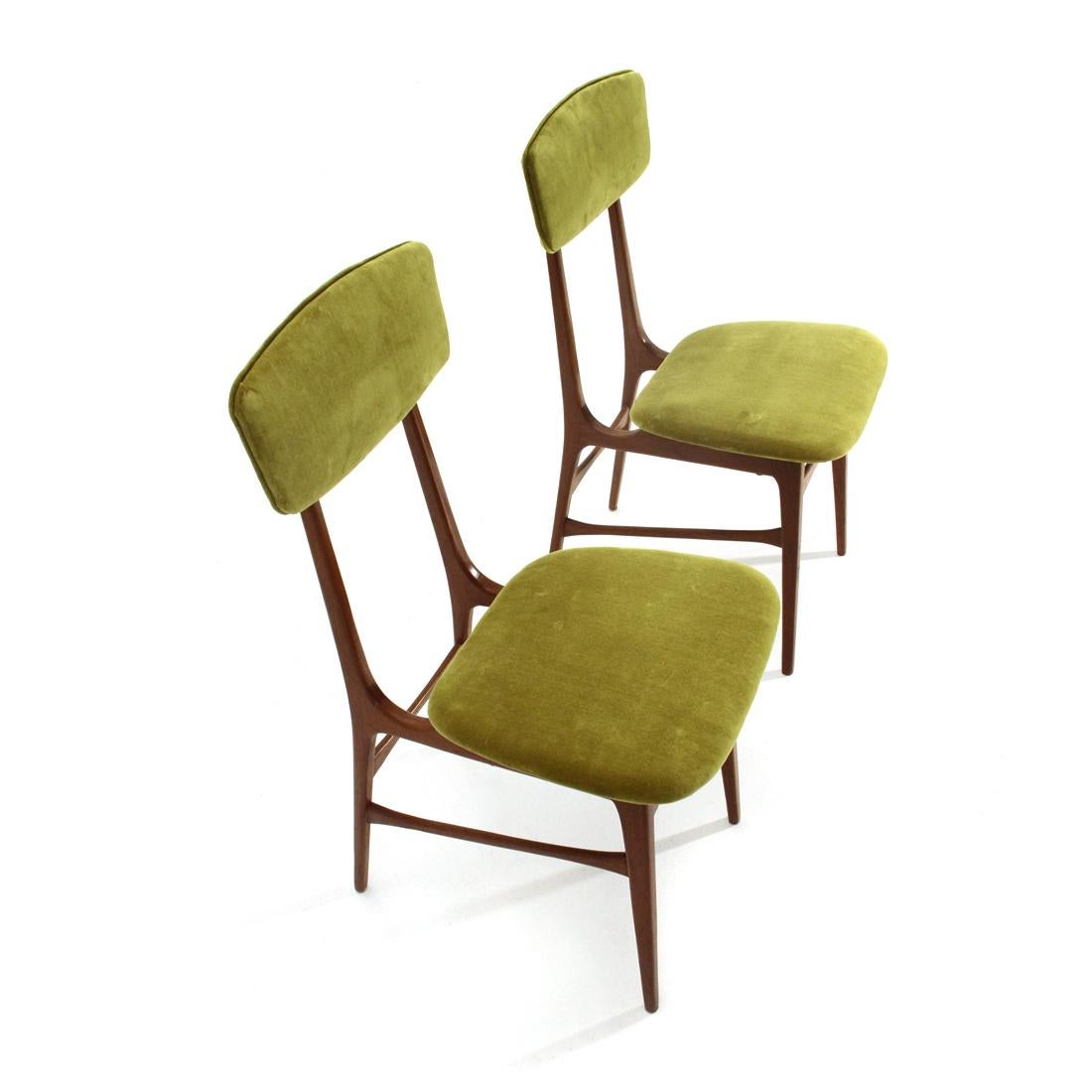 Pair of Italian-made chairs produced in the early 1960s.
Wooden structure.
Seat and back in curved plywood, padded and lined with new green velvet fabric.
Brass spacers.
Good general condition, some signs of normal use over time.

Dimensions:
