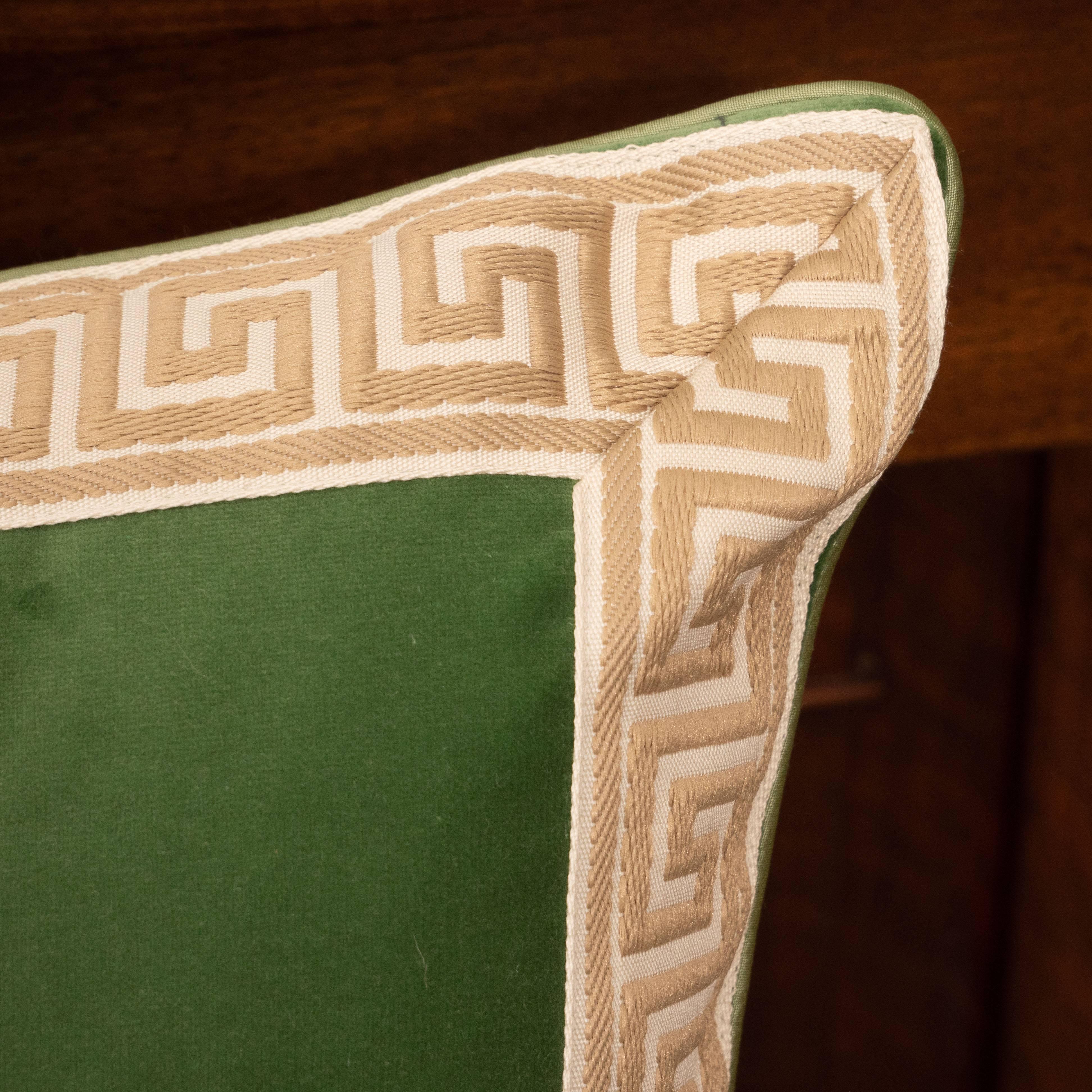 A pair of green velvet pillows with Greek key.