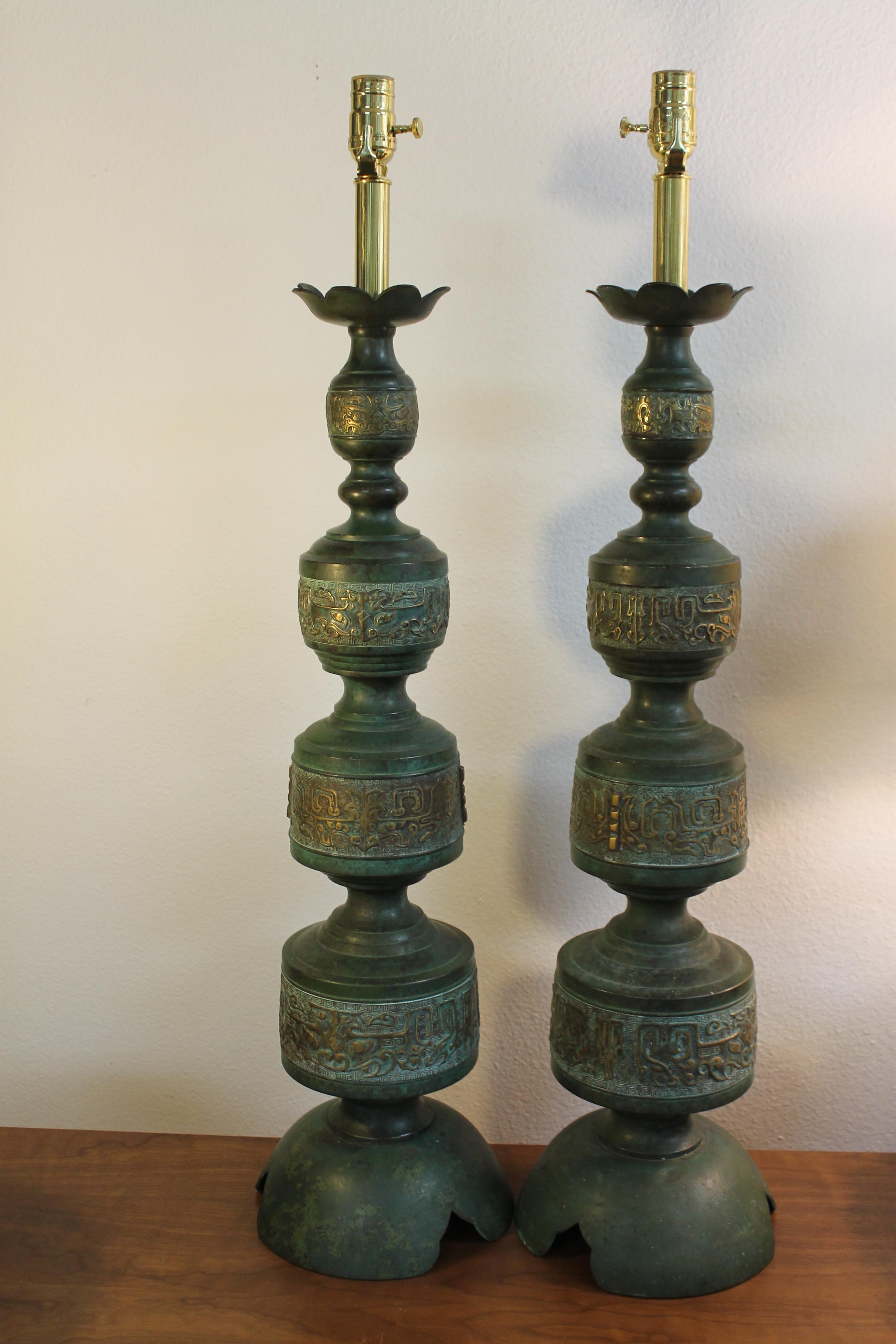 Pair of green brass patinated lamps. In the style of Frederick Cooper.  Looks like an Asian motif throughout. Lamps measure: 32.5