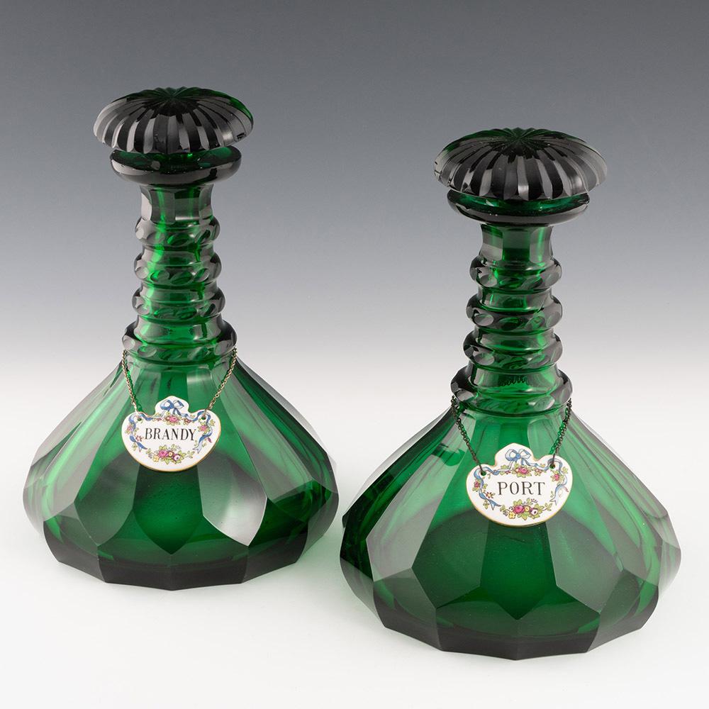 Heading : Pair of green Victorian decanters with labels
Period : Victoria – c1850
Origin : England
Colour : Deep green
Stopper : Radial mushroom
Neck : Slice cut with four moulded notch cut neck rings
Body : Slice cut ships decanter
Base :