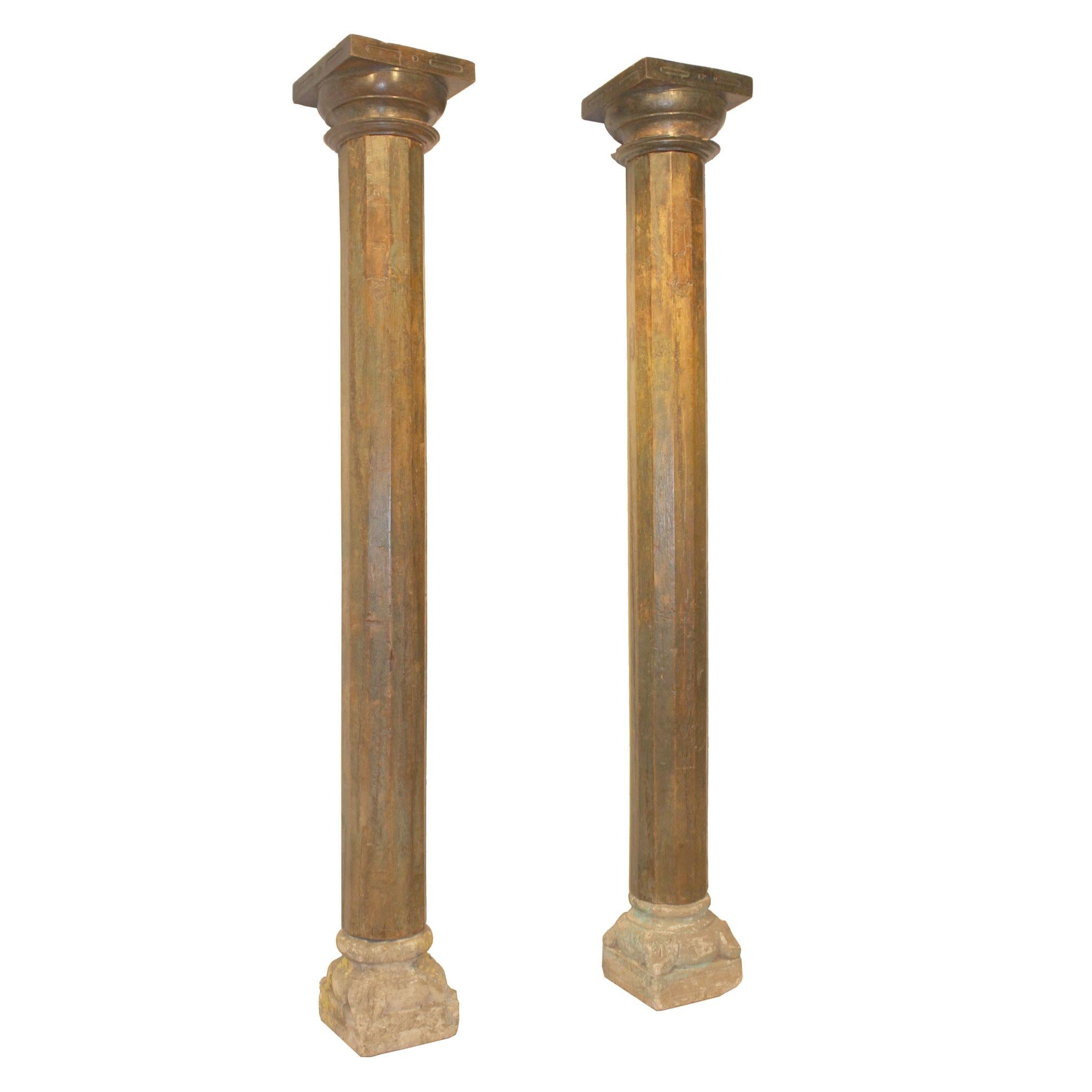 Pair of beautiful wood columns from a Haveli in Gujarat, India. The columns have carved wood capitals and stone bases. Originally used to adorn an entry in a traditional Indian Haveli. Assembly required.