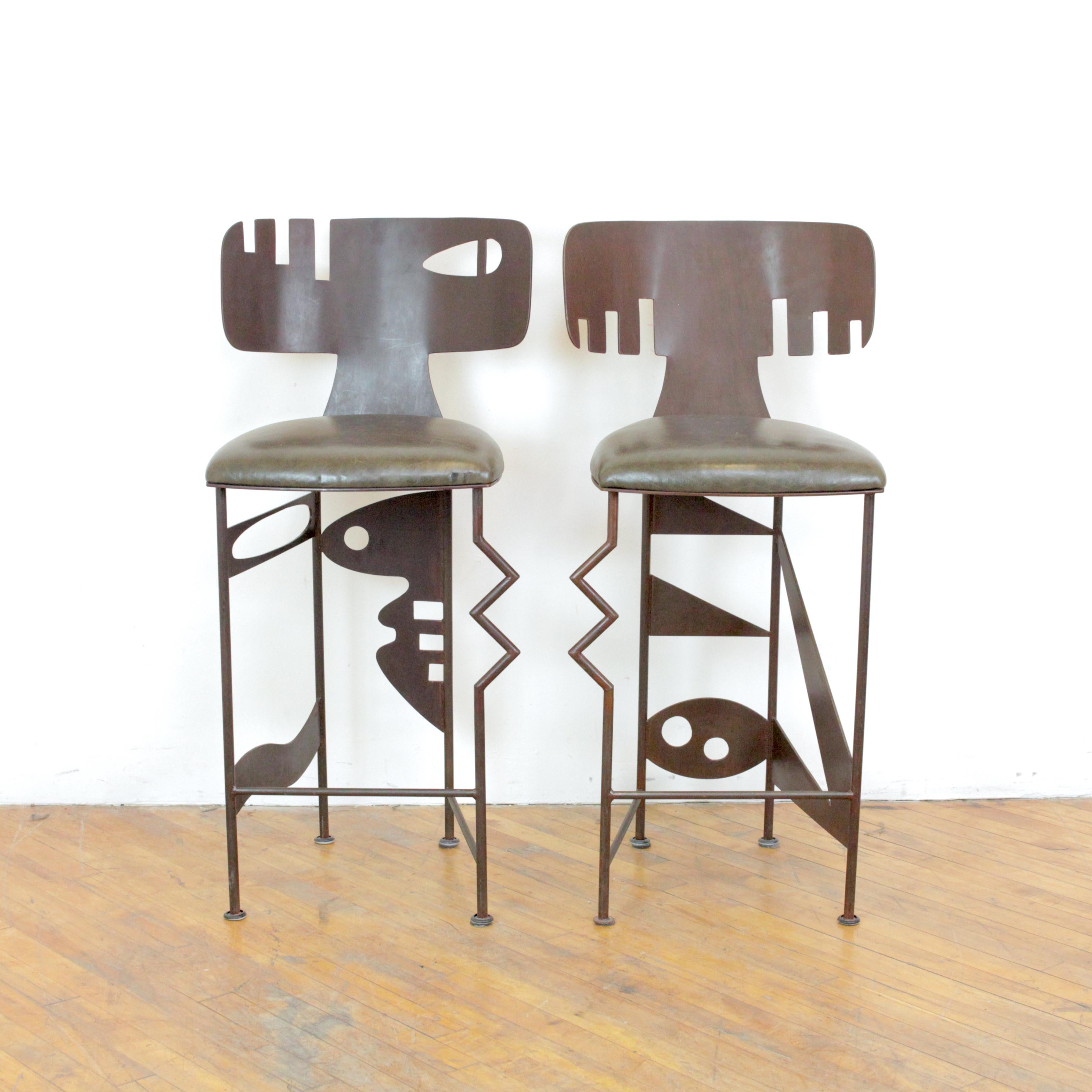 Pair of sculptural barstools by California artist Gregory Hawthorne constructed of acid-etched stainless steel and leather.  Hawthorne still has a gallery in Big Sur, California where his one-off designs and sculptures can still be purchased.  

17”