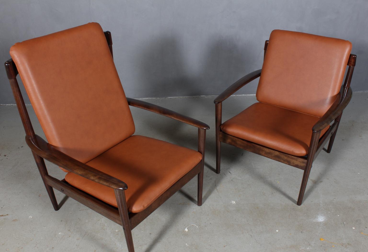 Pair of Grete Jalk armchairs in lacquered mahogany.

New upholstered cushions with tan pure aniline leather.

Model 56, made by Poul Jeppesen.