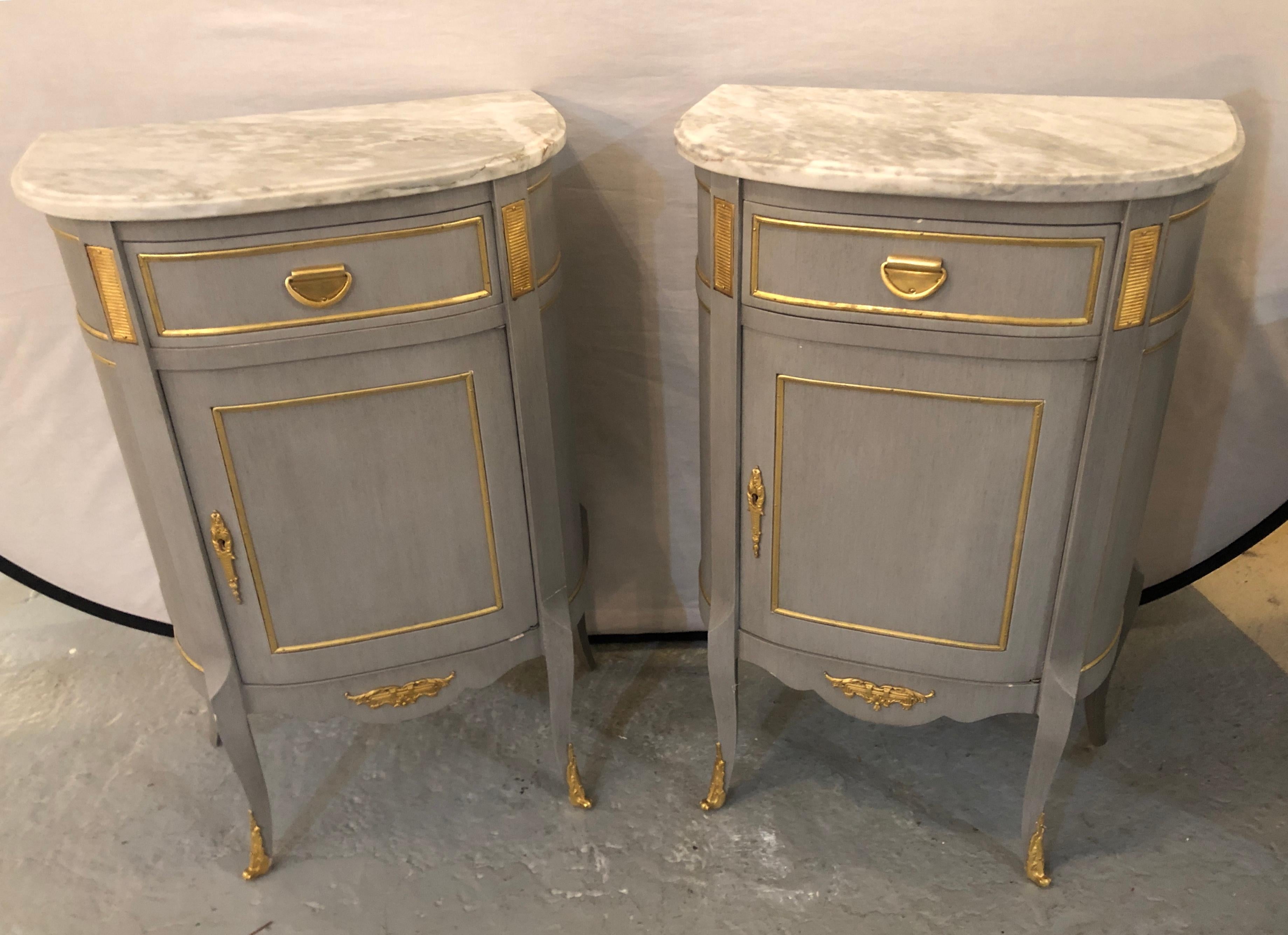 A finely constructed pair of Grayish blue painted marble top Louis XV style nightstands, Side tables or/ end tables. Each in the Louis XV style with bronze mounts and marble tops. The Demilune painted cabinets with a single shelved door under one