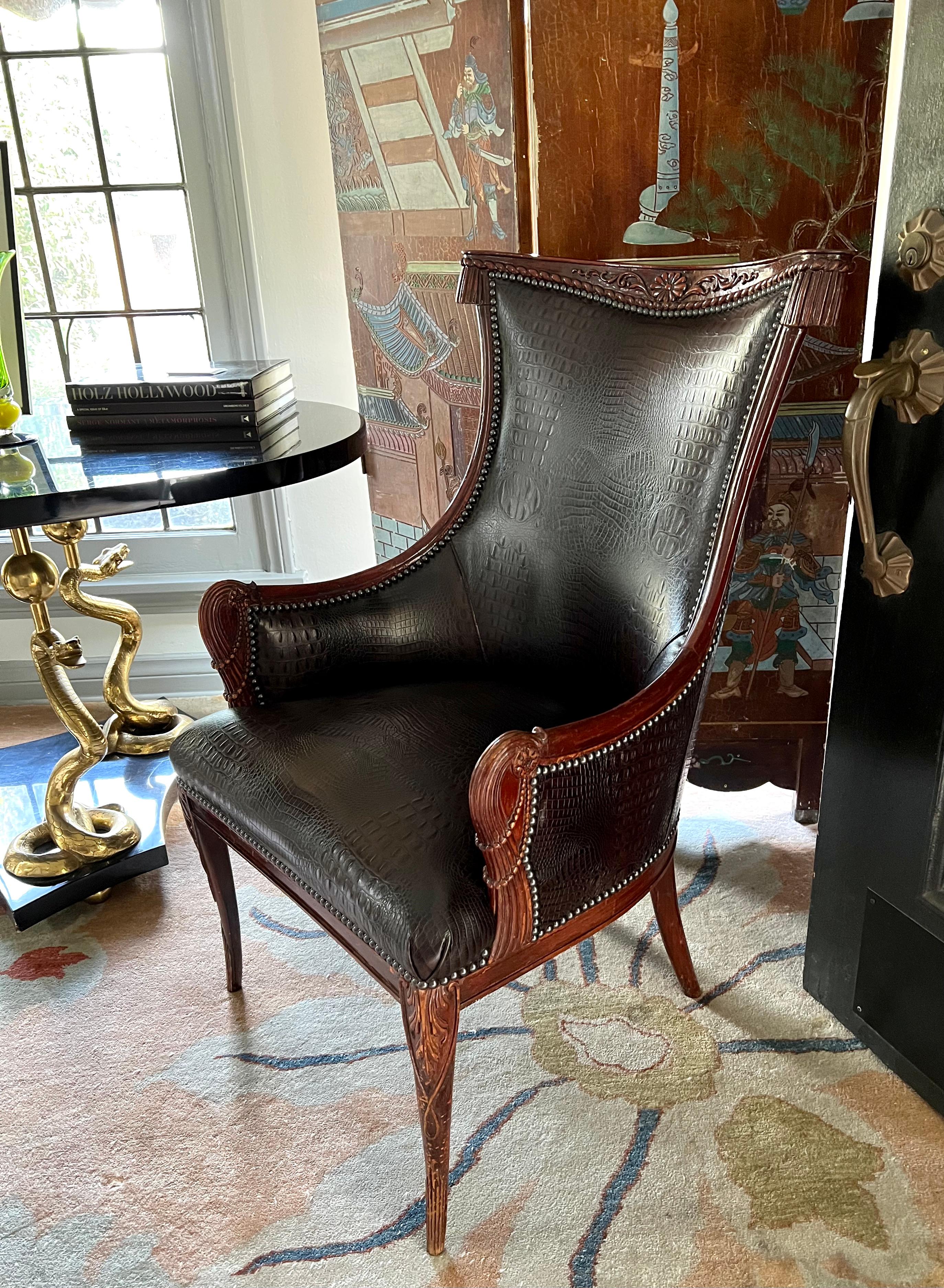 An original pair of Grosfeld House Hollywood Regency chairs, ca 1940's. The handsome pair have been re-upholstered in Crocodile pattern Leather. The frames are in excellent and stable condition.

The wood has been alone with many signs of
