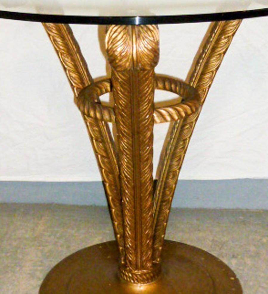 Wood carved and paint gilded plume base glass top side tables. They are created in the midcentury, Hollywood Regency style by Grosfeld House furniture company. These tables have highly detailed, carved accents on the three Plume feathers. The Prince