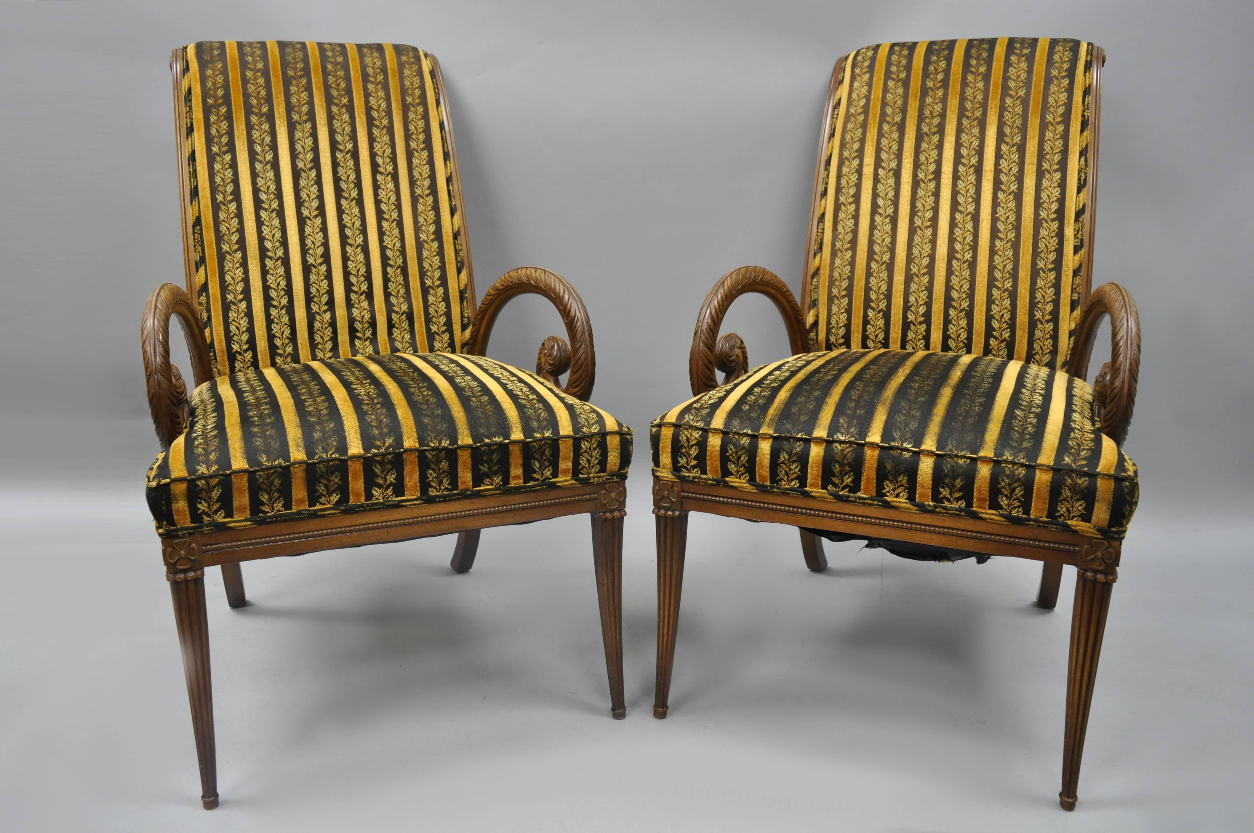 Pair of vintage Hollywood Regency mahogany armchairs with plume feather carved arms attributed to Grosfeld House. Item features wood construction, nicely carved details, tapered legs, sleek sculptural form, circa 1950s. Measurements: 40