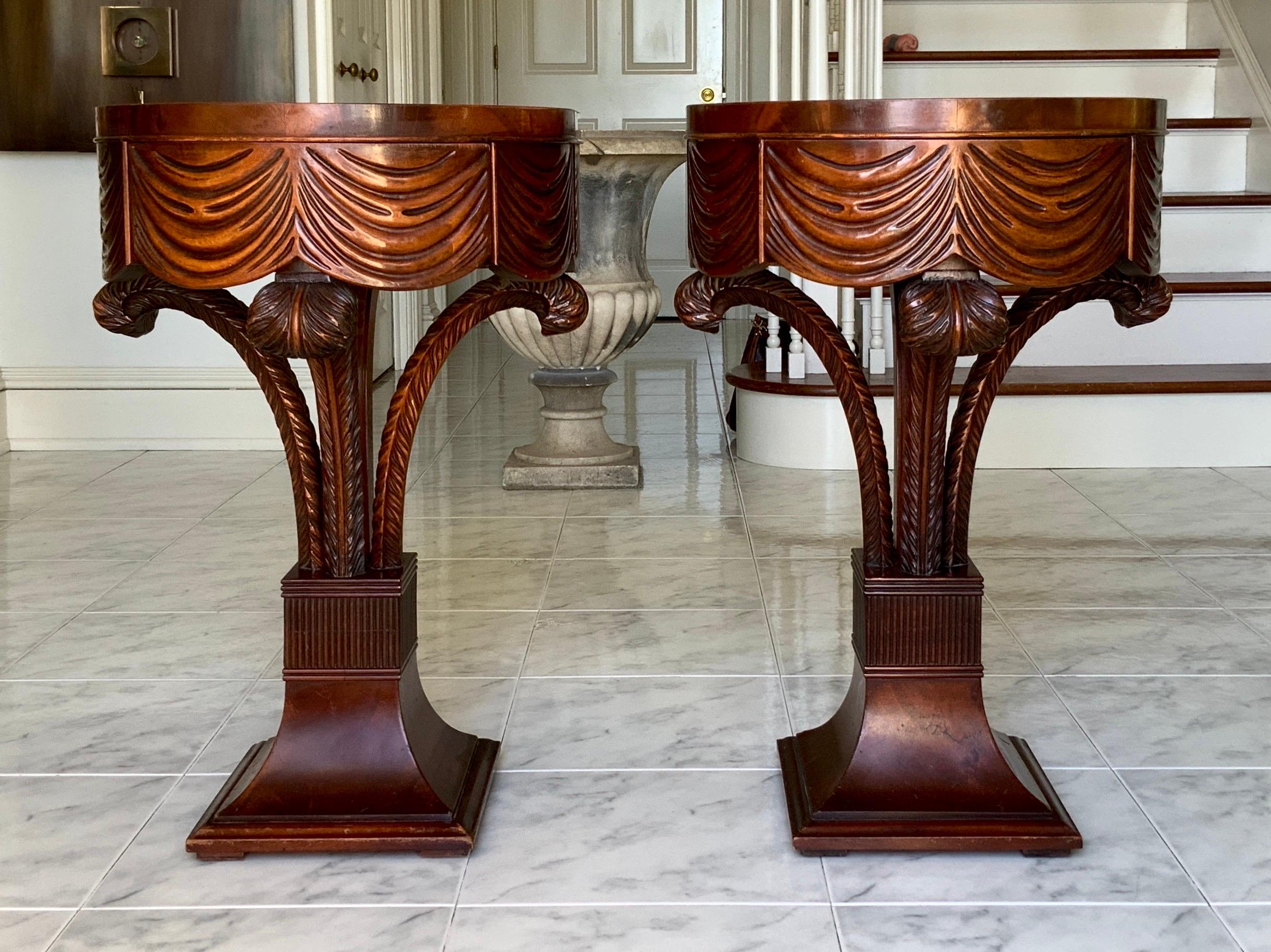 A gorgeous pair of 1940s Grosfeld House plume side tables.
Fabulous set of carved mahogany wood plumes holding a carved draped top with a hidden drawer. Hollywood Regency glamour with beautiful detailed workmanship.
