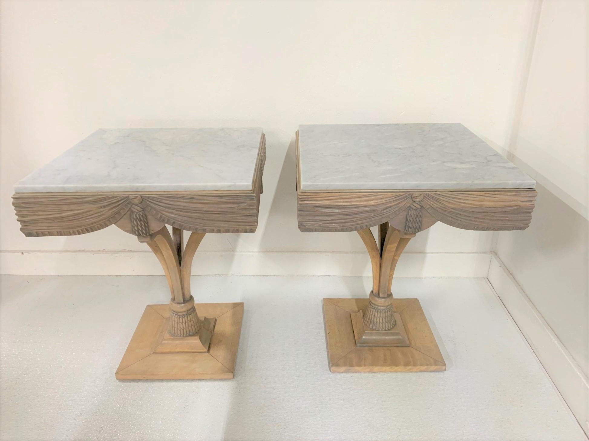 Pair of Grosfeld House plume marble-top side tables. The tables are bleached maple with Carrara marble tops and decorative bases. Hollywood Regency style.
