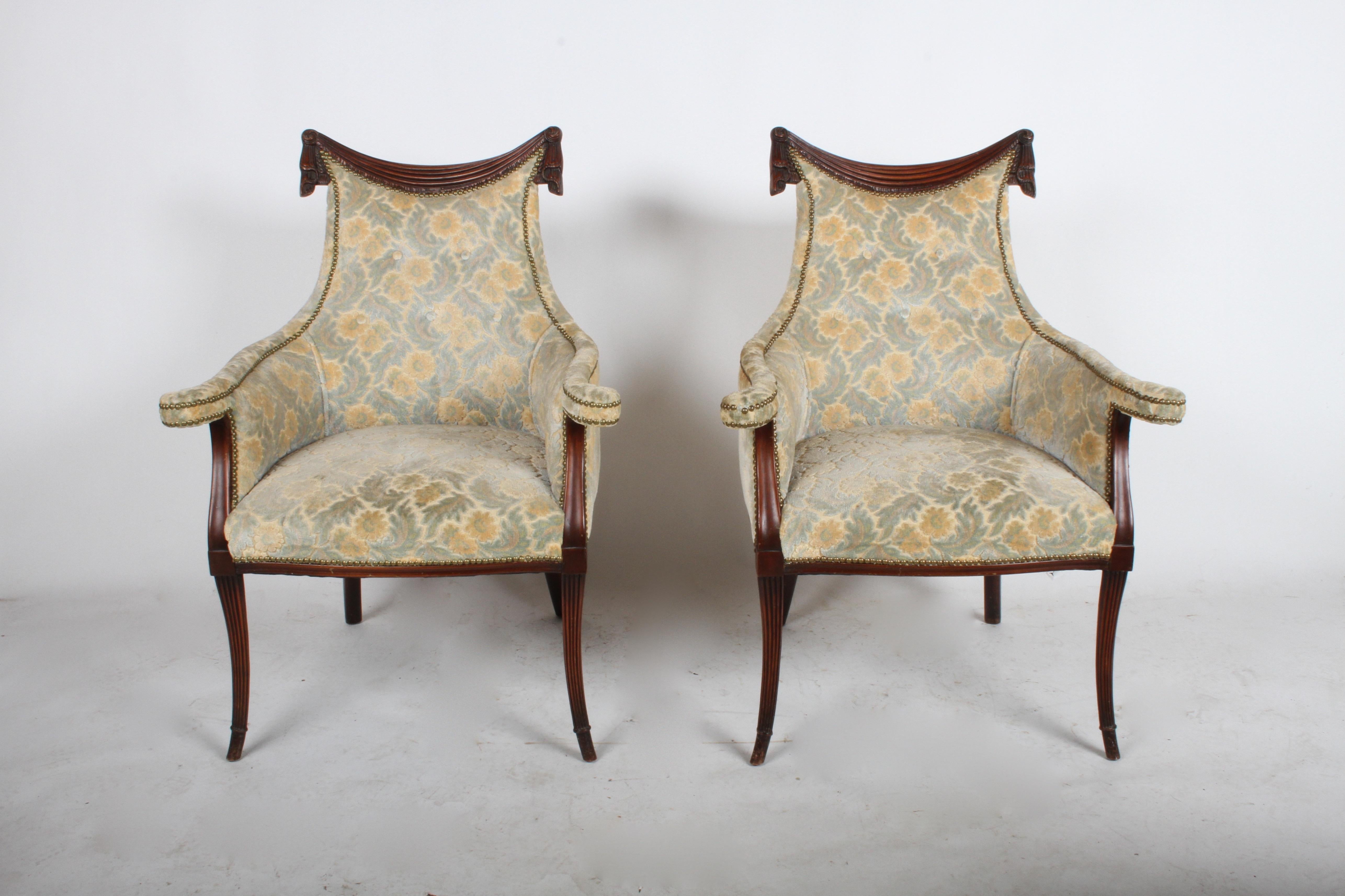 Pair of glamorous Grosfeld House swag and drape motif club chairs, circa 1940s. Shown in original condition, with older re-upholstery with brass tacks. Mahogany frame in nice condition, showing some marks on legs. Seat depth is 20