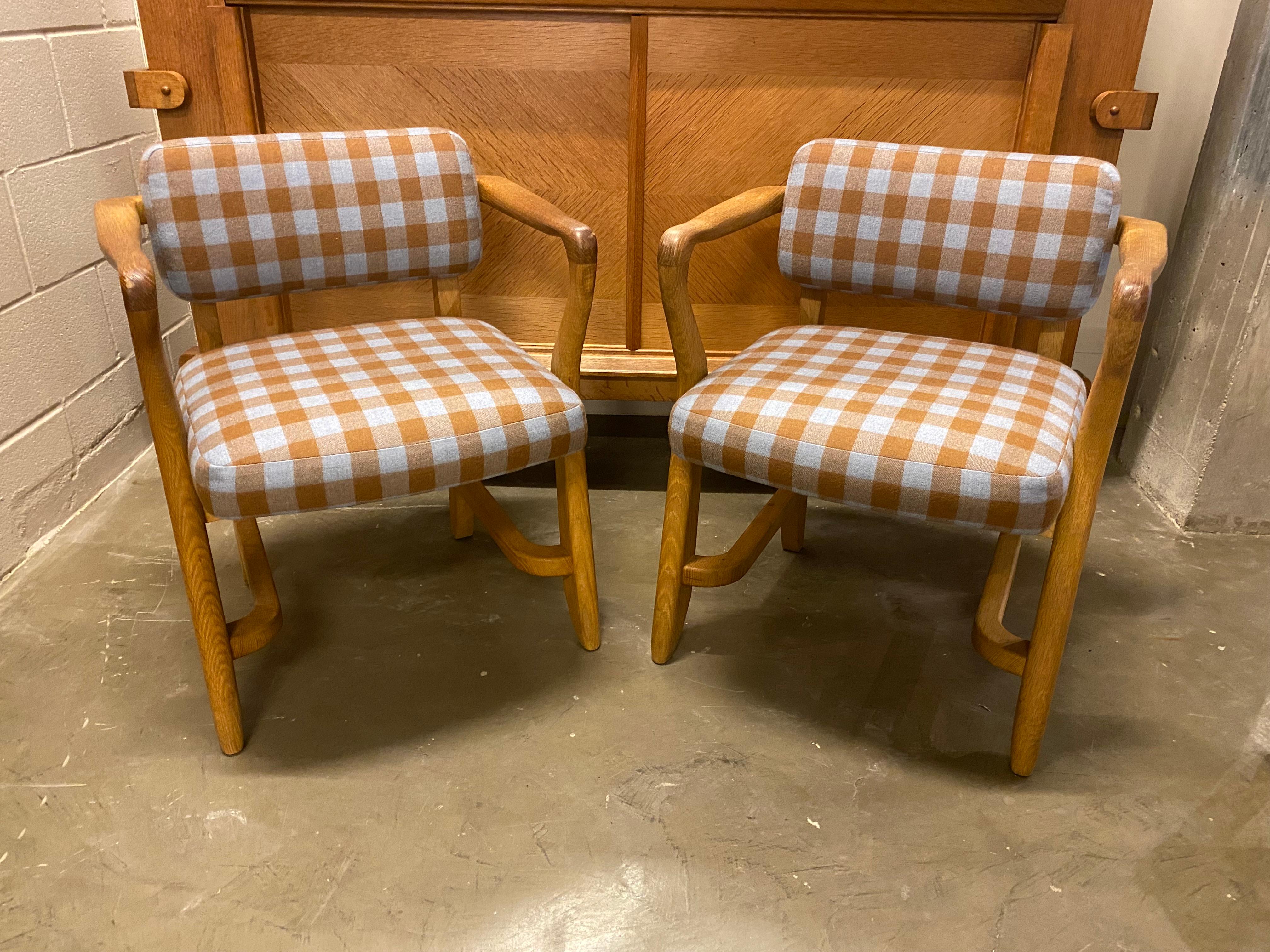 Charming pair of solid French oak armchairs by collectable design duo, Guillerme et Chambron. New custom upholstered seats and backs in Holland and Sherry wool plaid. Chairs are quite comfortable and sturdy and fabric is soft to the touch. France,
