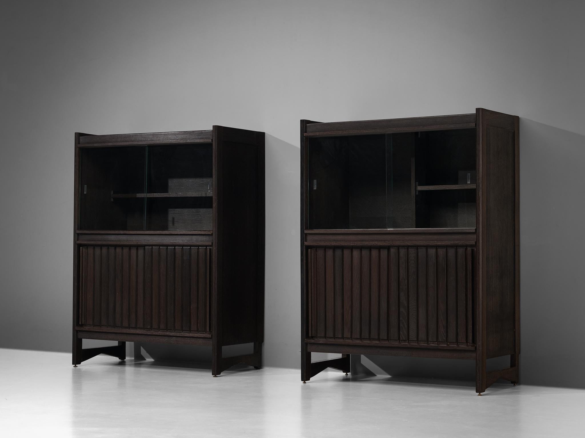 Pair of Guillerme & Chambron, cabinets, oak, glass, France, 1960s

These sculptural cabinets are made by the designer duo Guillerme & Chambron. The piece is executed in solid, stained oak and features sculptural lines and edges. The piece holds
