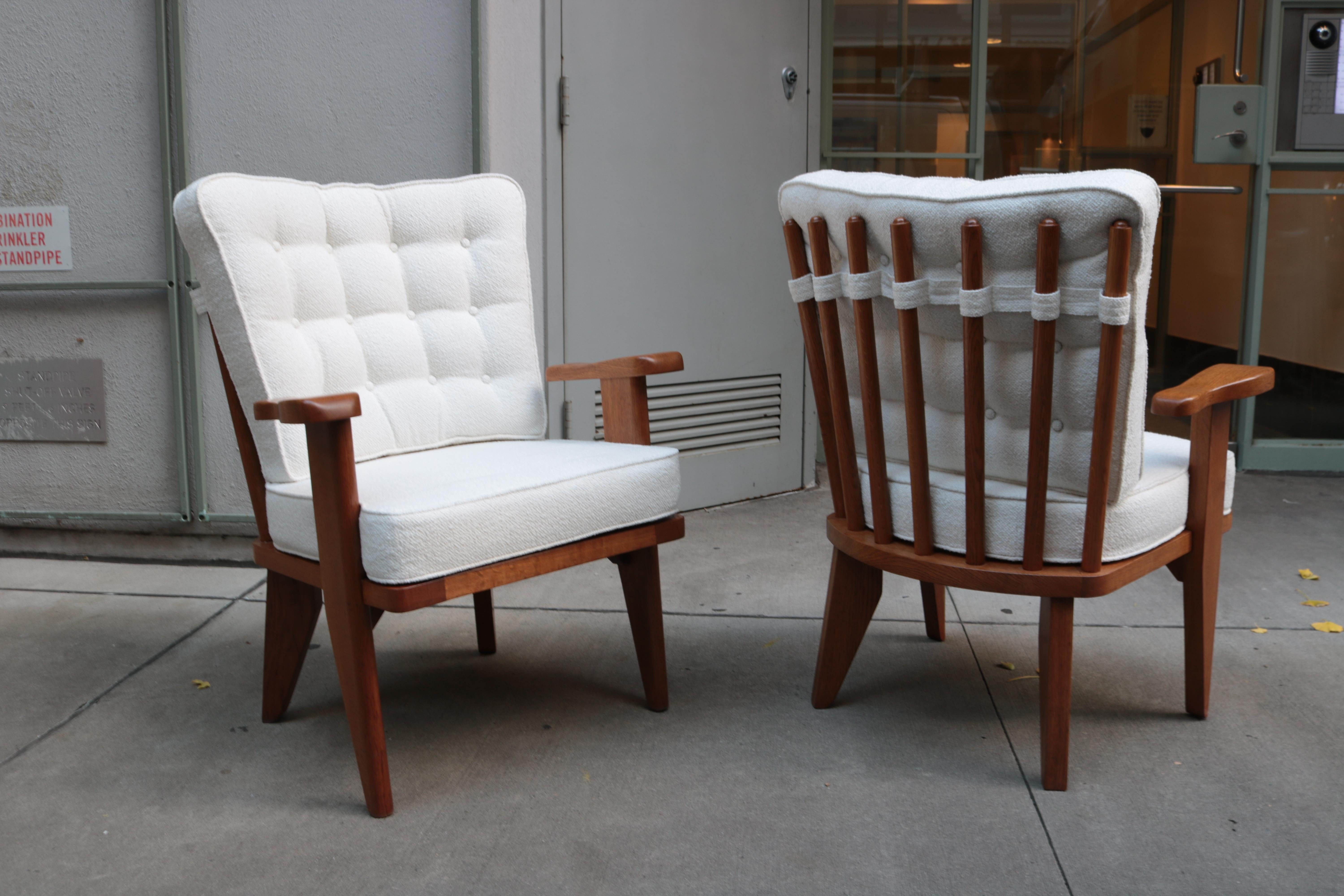 Pair of Guillerme & Chambron designed Modernist armchairs. 
Solid oak frame with upholstered seat and back cushion.
