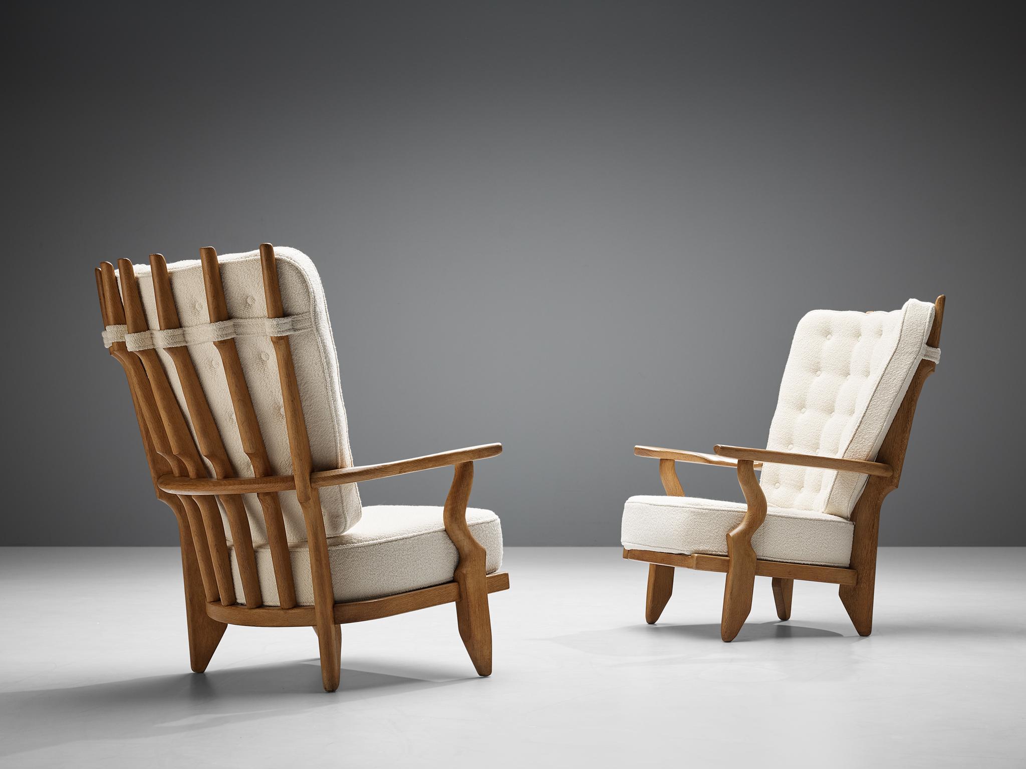 Guillerme et Chambron, Pair of 'Grand Repos' lounge chair oak, white woolen Pierre Frey upholstery, oak, France, 1960s.

Guillerme and Chambron are known for their high quality solid oak furniture, from which this is another great example. These