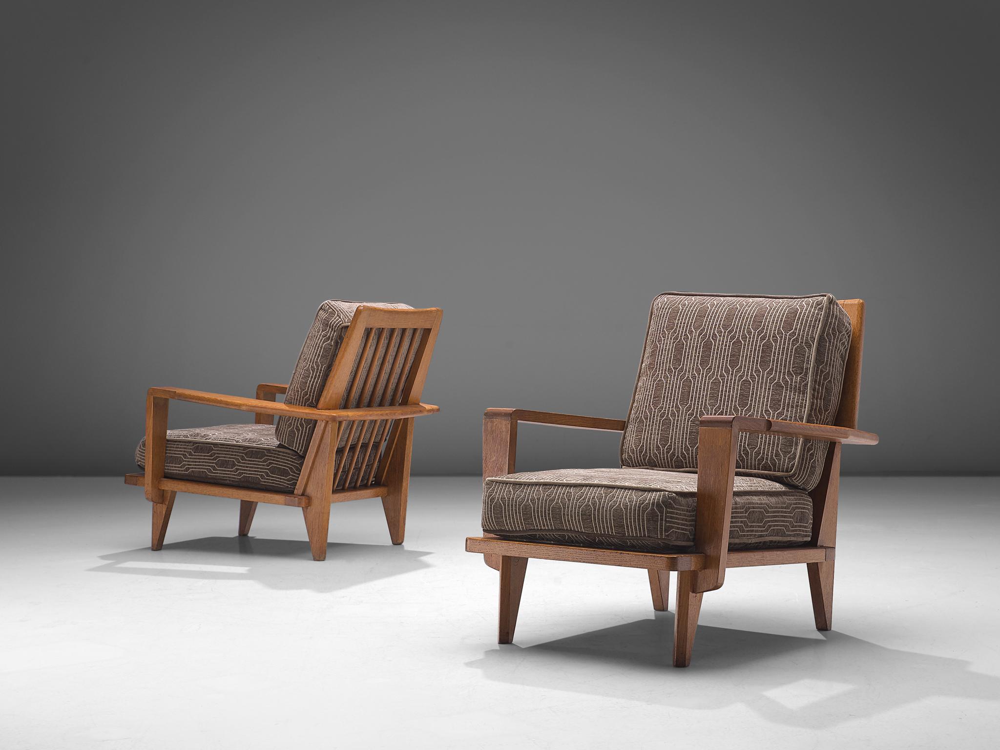 Guillerme et Chambron, easy chairs, fabric and oak, France, 1950s

This sculptural set of easy chairs by Guillerme and Chambron is very well executed and made out of solid, carved oak. The back features an interesting open construction with vertical