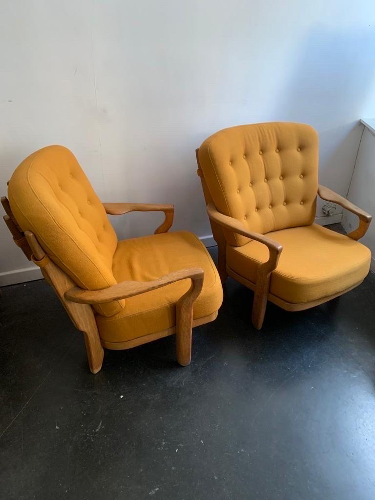 A large pair of oak arm chairs 