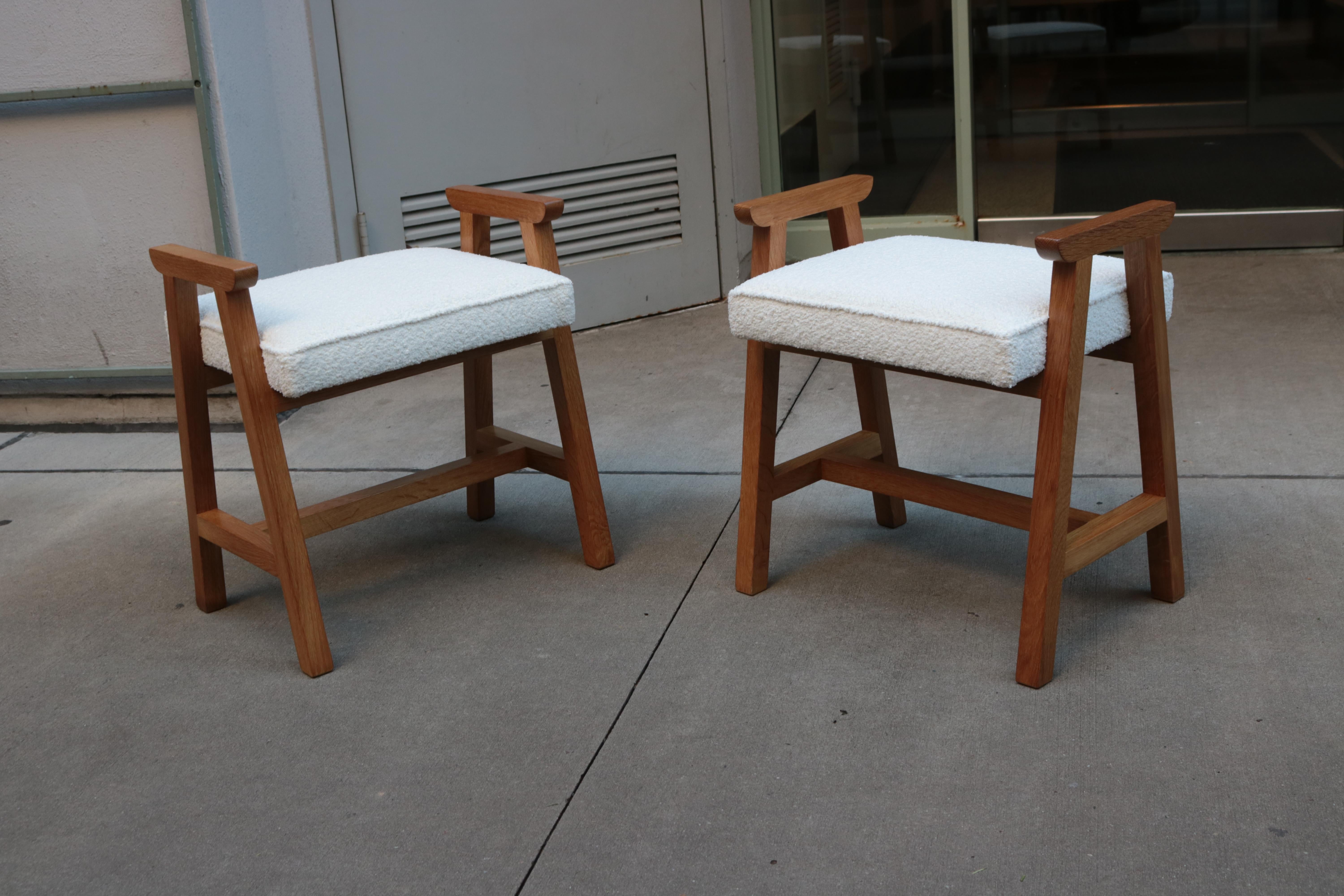 A pair of Guillerme et Chambron stools. 
Oak frames and upholstered seats with boucle style fabric.


