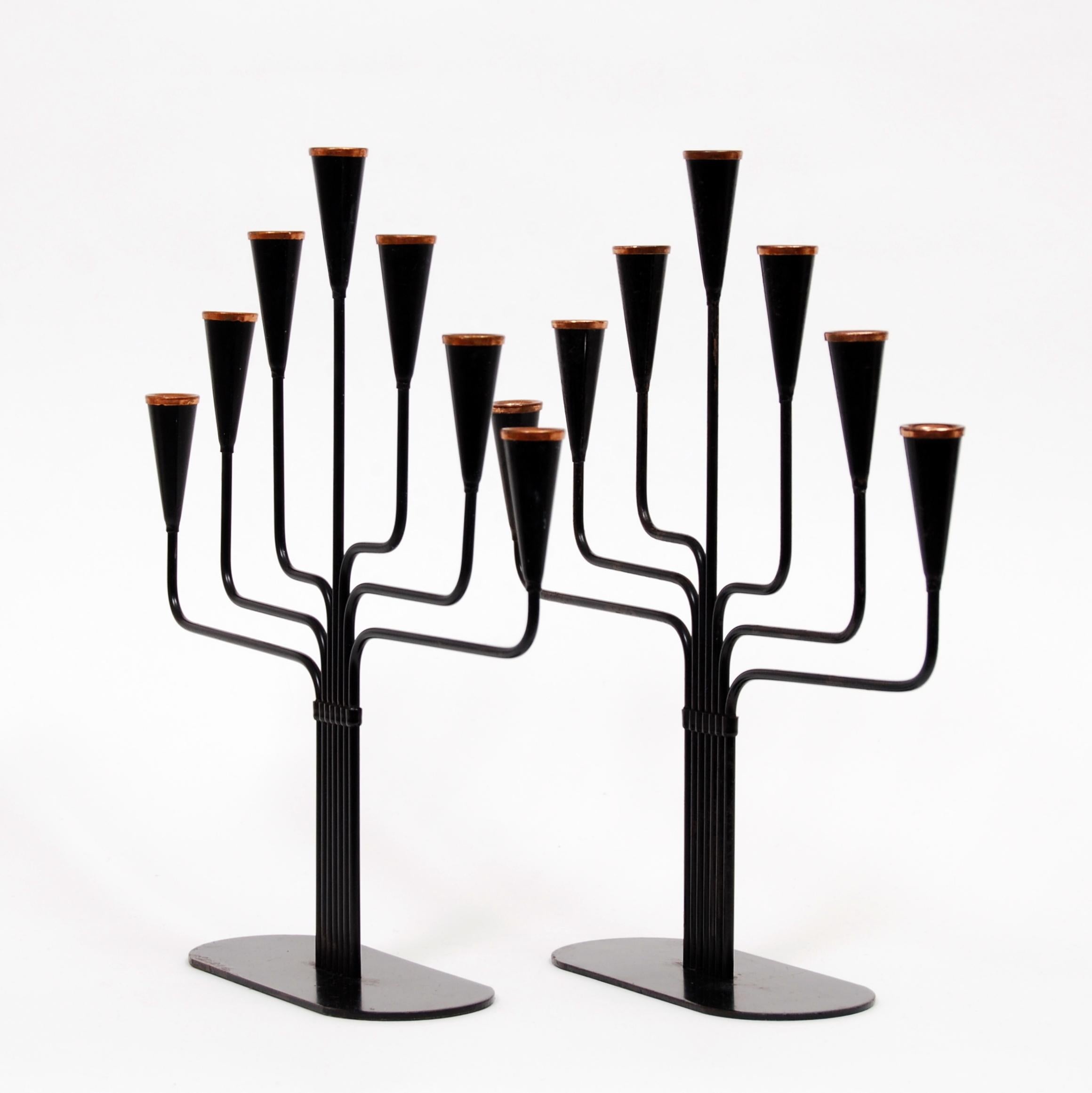 A pair of Gunnar Ander seven-armed candelabras in metal with bronze tops. Manufactured by Ystad Metall in the 1970s.
    