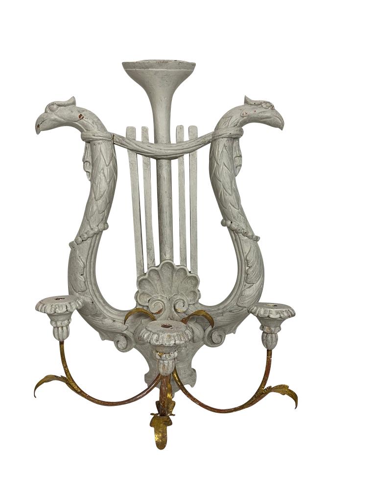 Pair of Gustavian white painted lyre form candle sconces, late 20th century, carved composition with painted and gilt finish, applied metal arms, three light form, the lyre ends terminating in eagle's heads. Highly decorative and a large