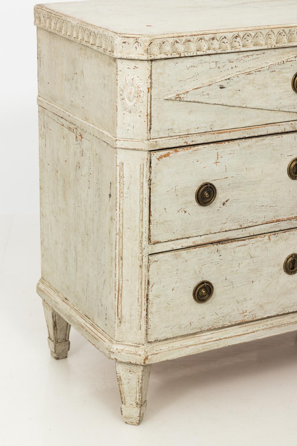Pair of white painted Gustavian style commodes with lozenge detail on the drawer front, circa 1860s.
 