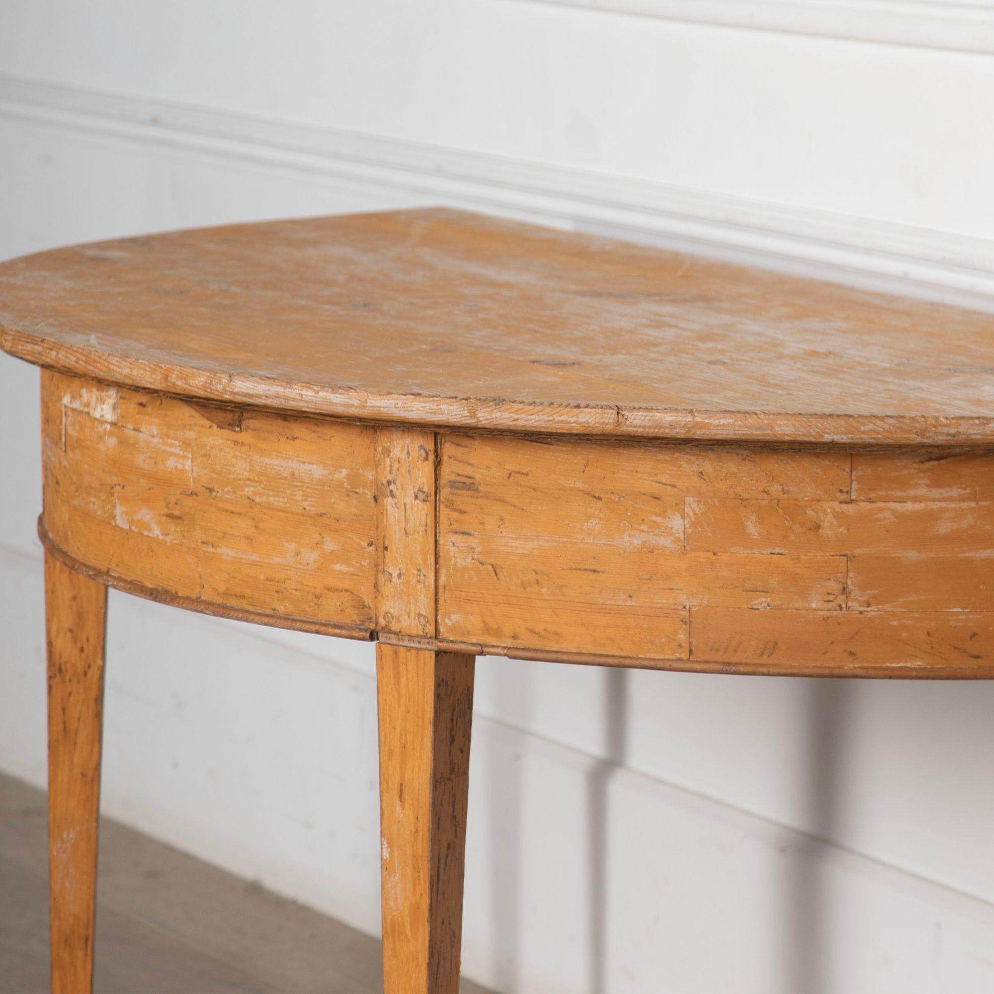 An unusually large scale pair of Gustavian period demilune tables in traces of original decoration.