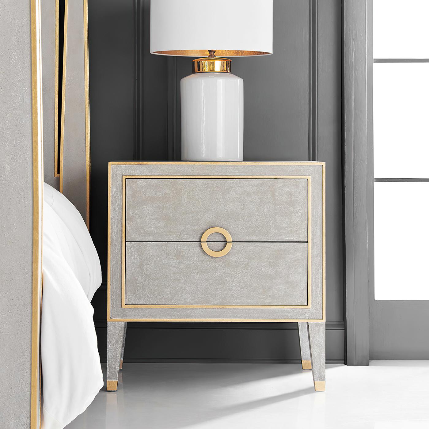 This beautifully crafted Neo Classic Swedish-inspired nightstand features an elegant and classic grey finish, accented with delicate gold trim that highlights its refined design.

The two spacious drawers are adorned with a unique circular solid