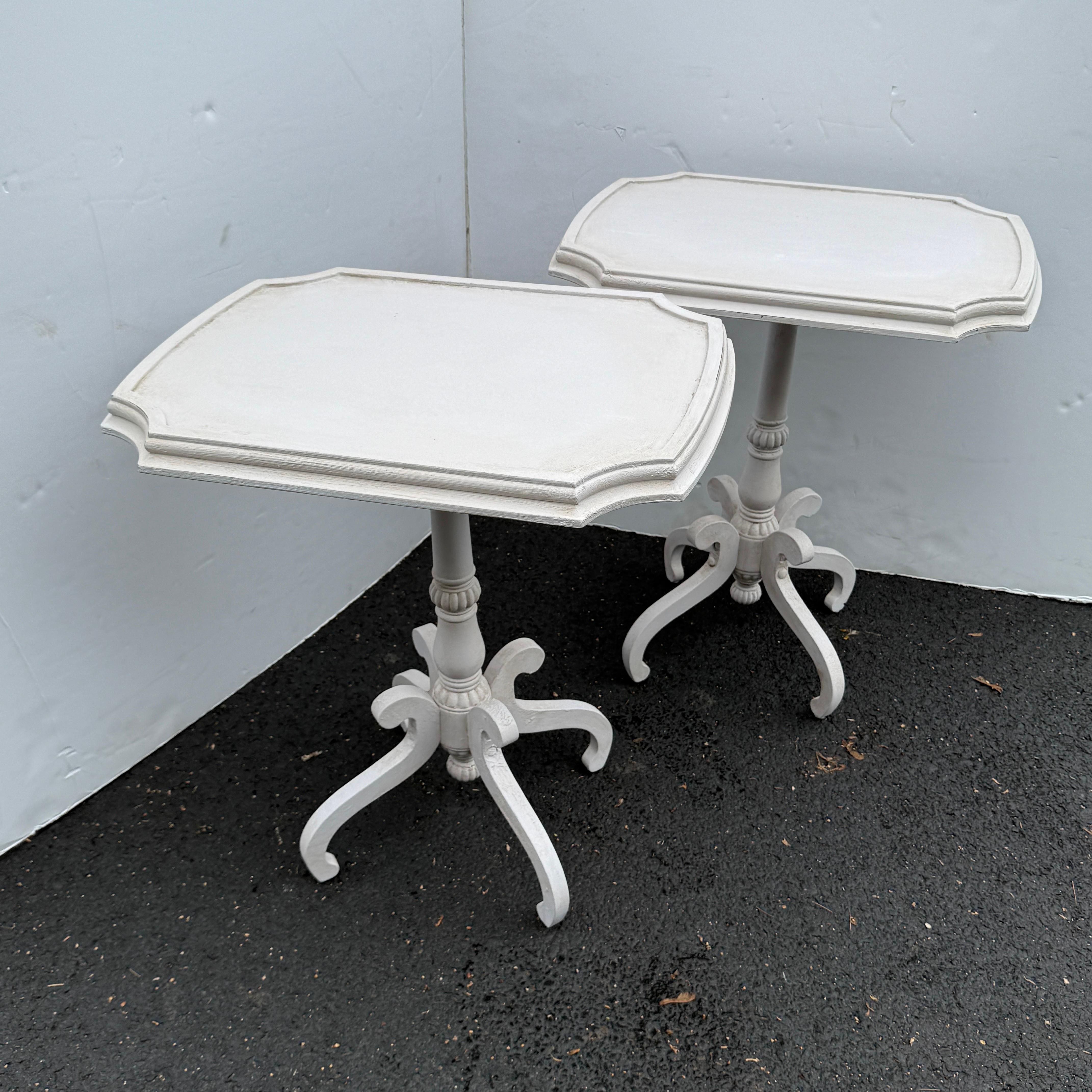 Classic pair of side tables, hand painted in a neutral creamy shade. The tables tops with rounded corners and baluster form and scrolled base create an architectural balance, imbuing these with a sense of grace and sophistication. This set certainly