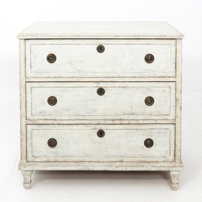 A storied Swedish Baroque cabinet dating to the mid-18th century Gustavian period. This antique cupboard has a gorgeous patina to its restored finish, where many layers of old paint were dry scraped to show the natural wood underneath. A stunning