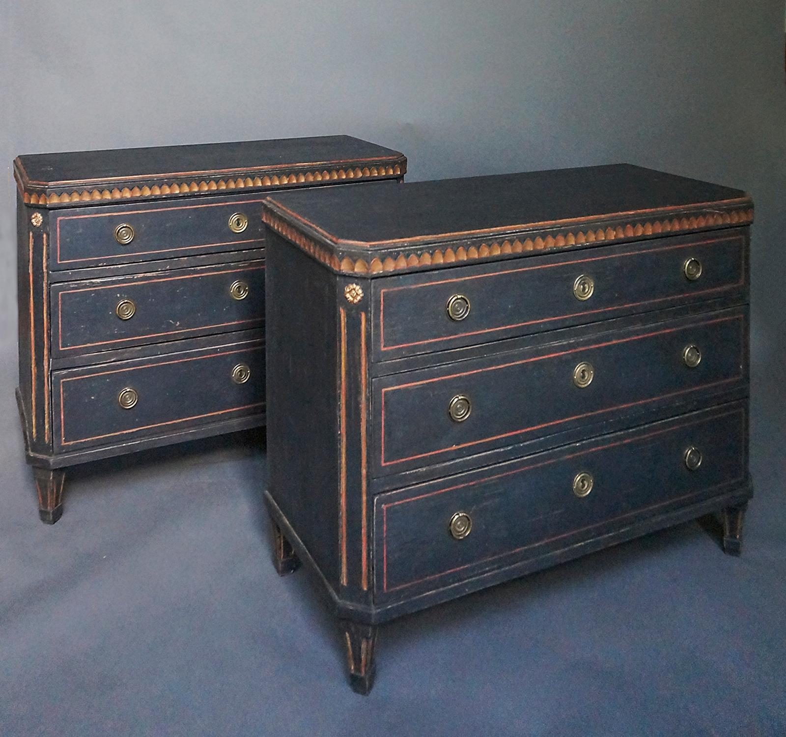 Pair of black three-drawer chests, Sweden circa 1880, in the Gustavian style. Shaped tops with lamb’s tongue molding, canted and reeded corner posts, and tapering, reeded feet. Brass pulls and escutcheons.