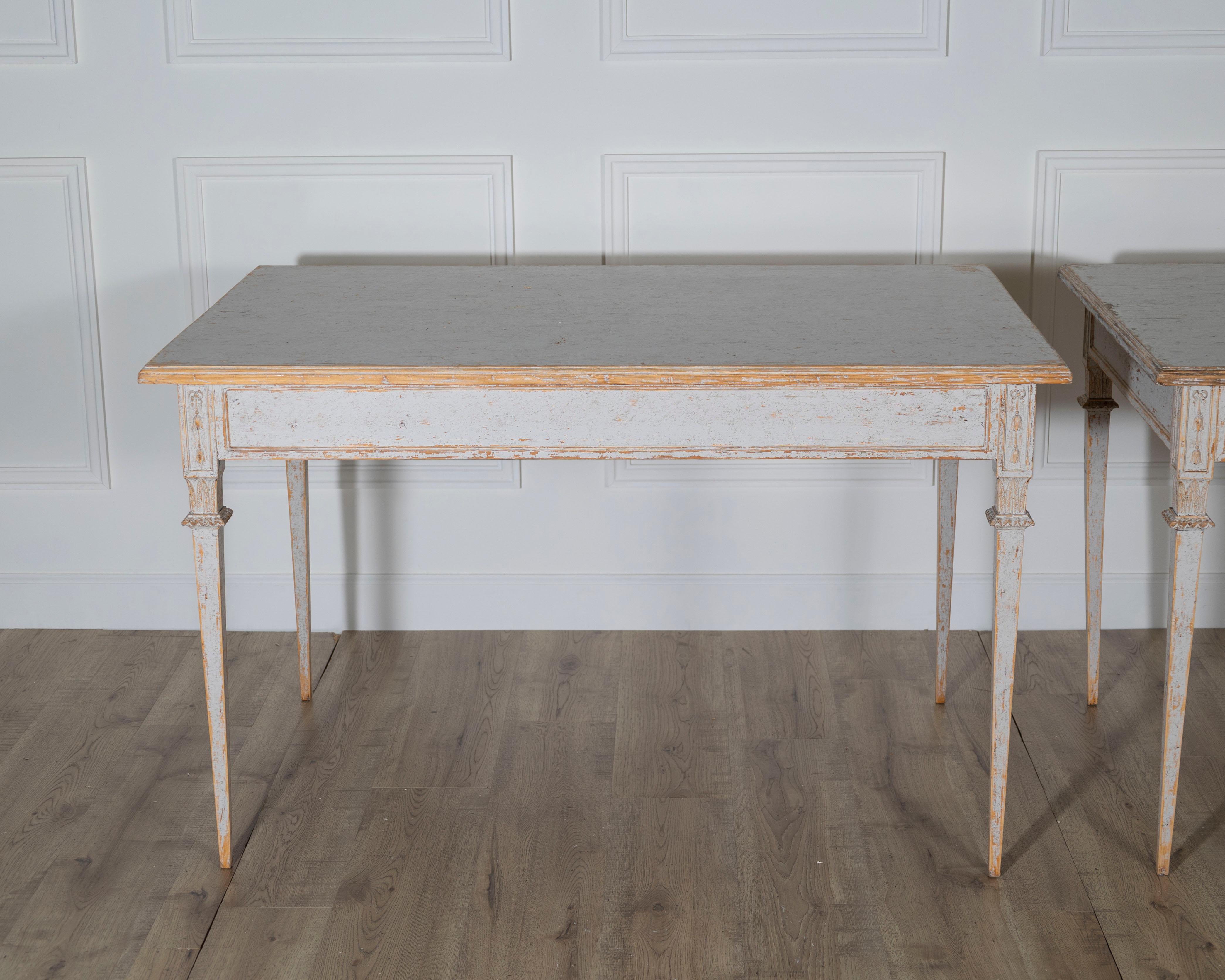A rare and elegant pair of Gustavian style tables, repainted in a soft light gray that enhances their timeless neoclassical form. Finding such tables as a matched pair is unusual, making them especially desirable for collectors and designers alike.