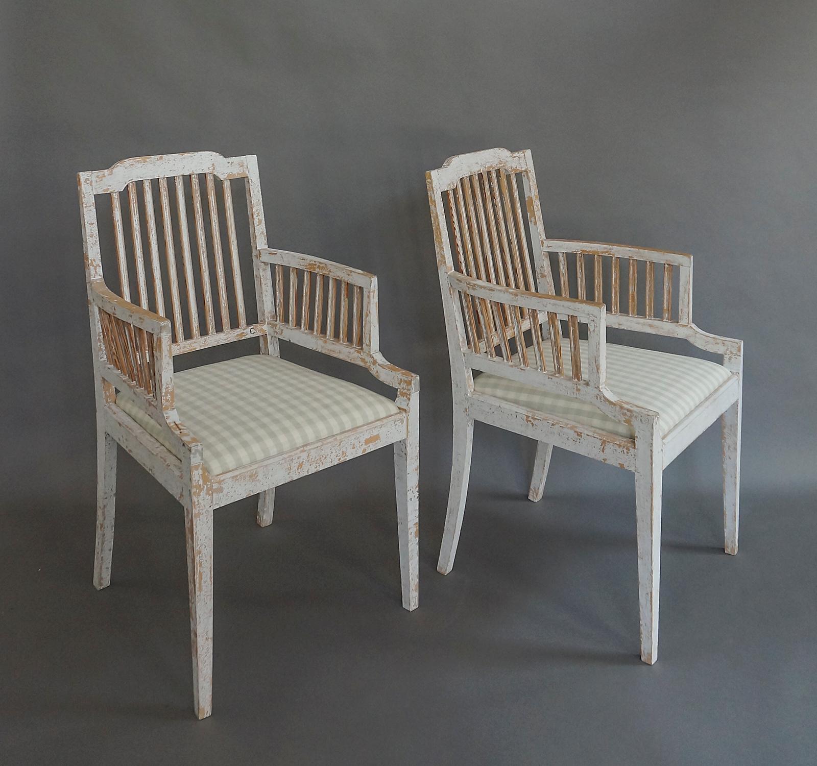 Pair of Swedish stick-back armchairs in the Gustavian style, circa 1860, scraped to the original paint. The slip seats have been newly upholstered in a green homespun linen check. Great condition, sturdy and comfortable.