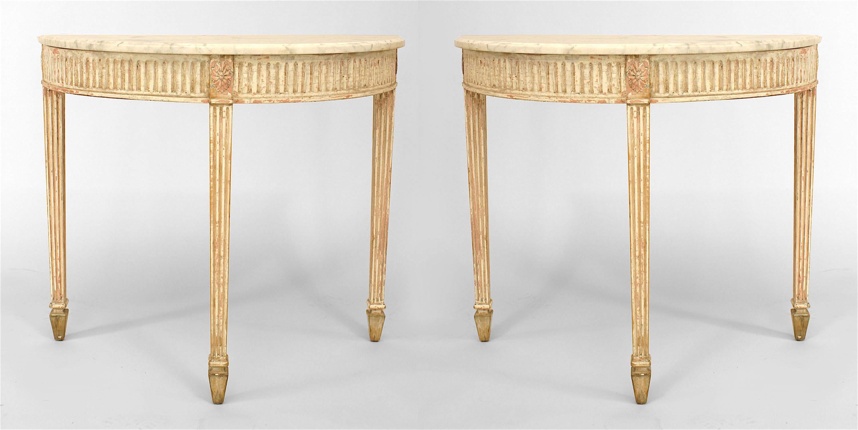 Pair of nineteenth century Swedish Gustavian white painted demilune consoles with white marble tops over fluted aprons and three fluted legs.