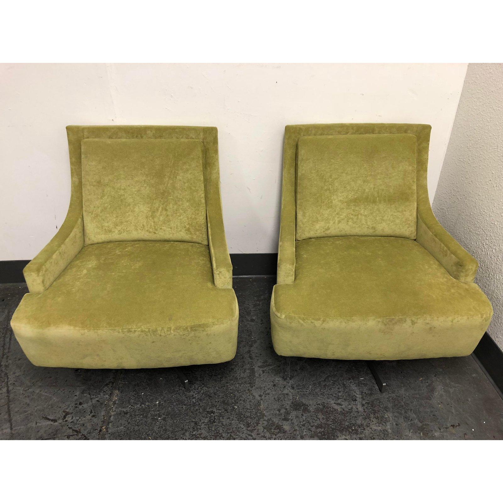 A pair of Barbara Barry Scoop chairs from HBF. Upholstered in a pastel green with vibrant sheen. Subtle curves and sloped lines deliver an overall smooth appearance simultaneously Classic and fresh. The four pronged base swivels and self-centres.