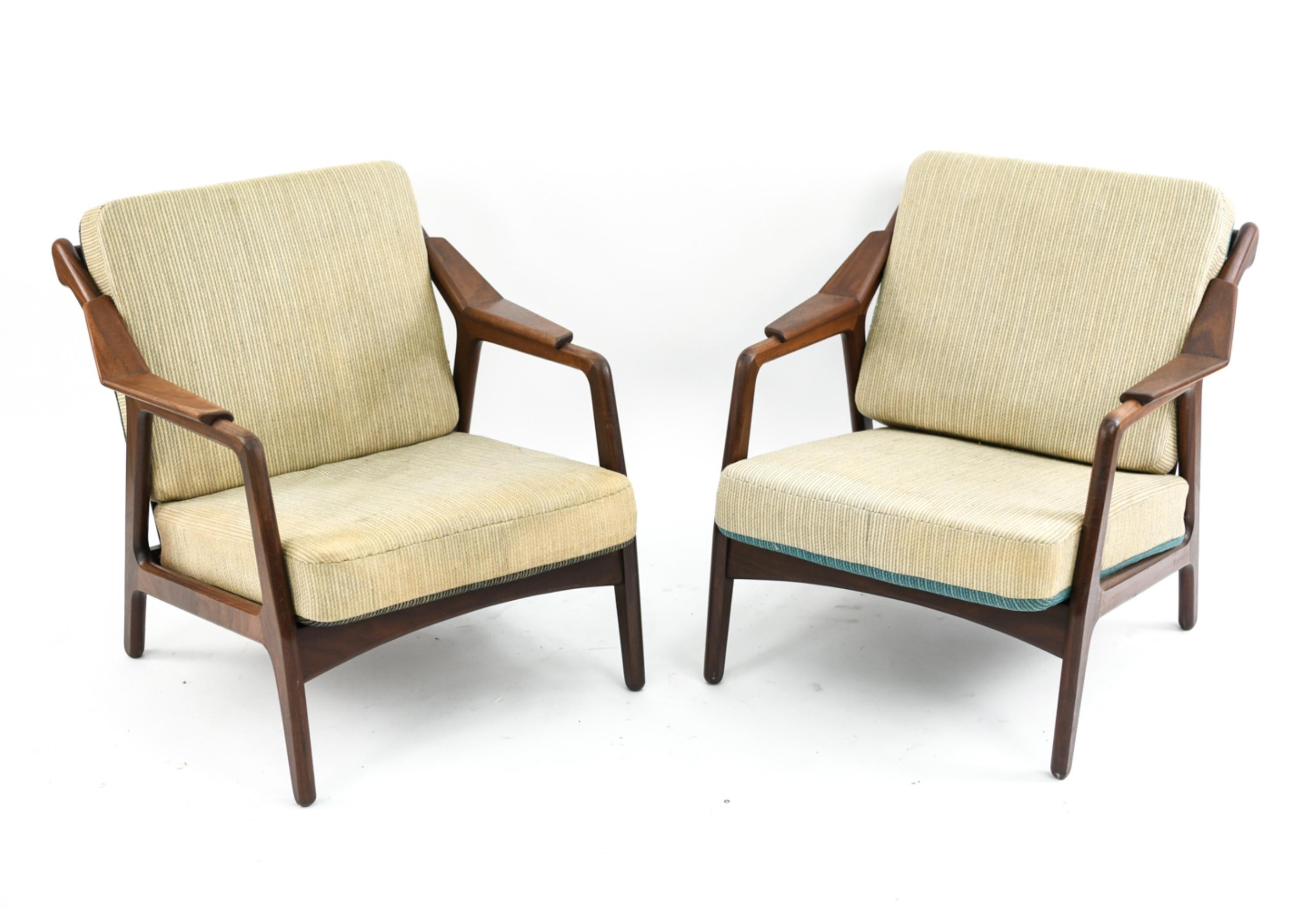 This is a fabulous pair of lounge chairs designed by H. Brockmann-Petersen, circa 1950s. This design is a highly sought after example of Scandinavian Modern style and features attractively angular wooden frames.