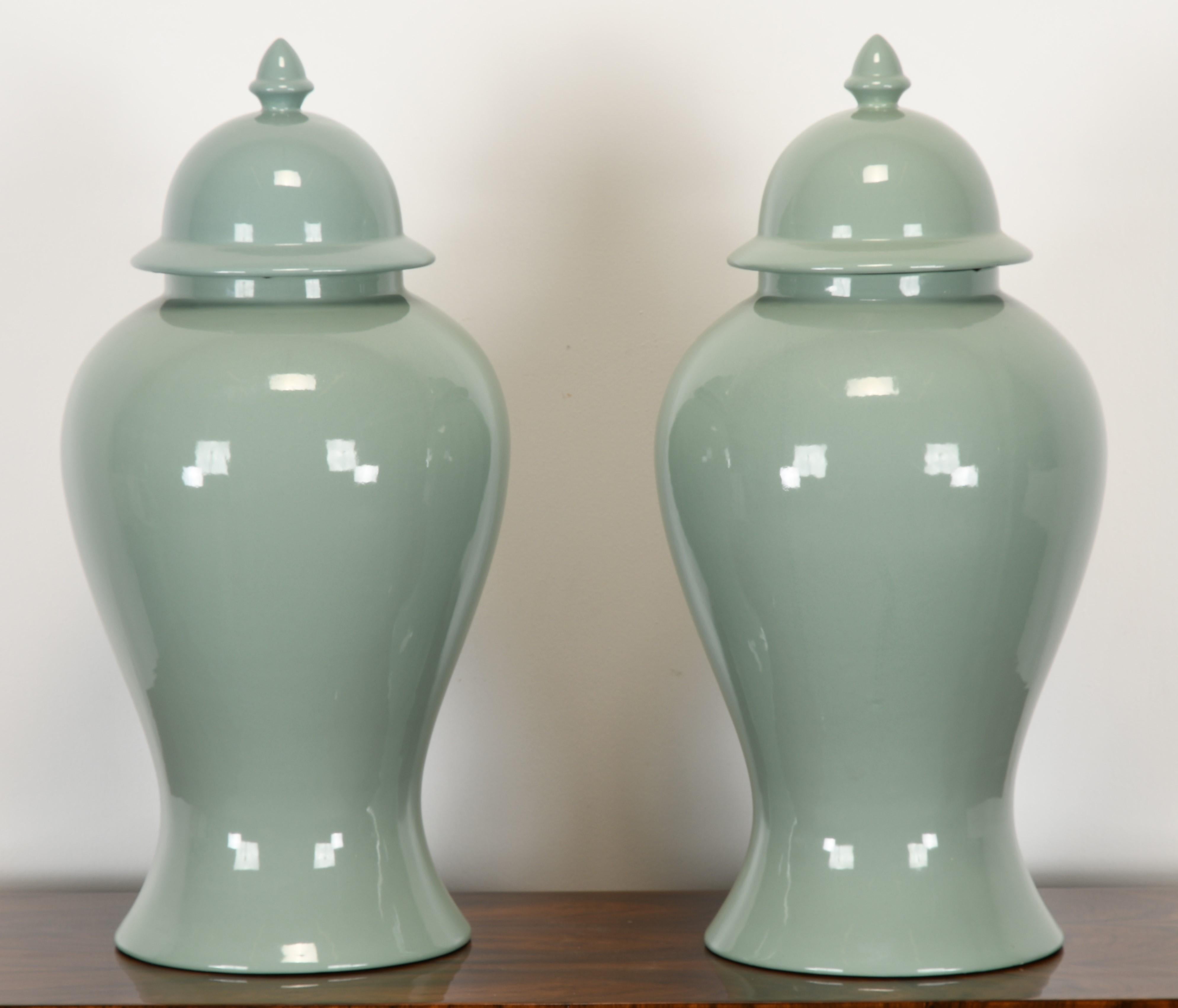 A classical pair of Celadon Ginger Jars by Haeger, USA, 1980s. The ginger jars are in very good condition. One lid has a small chip to the interior edge, as shown in images. The bottom of the jars has been predrilled and can be made into table