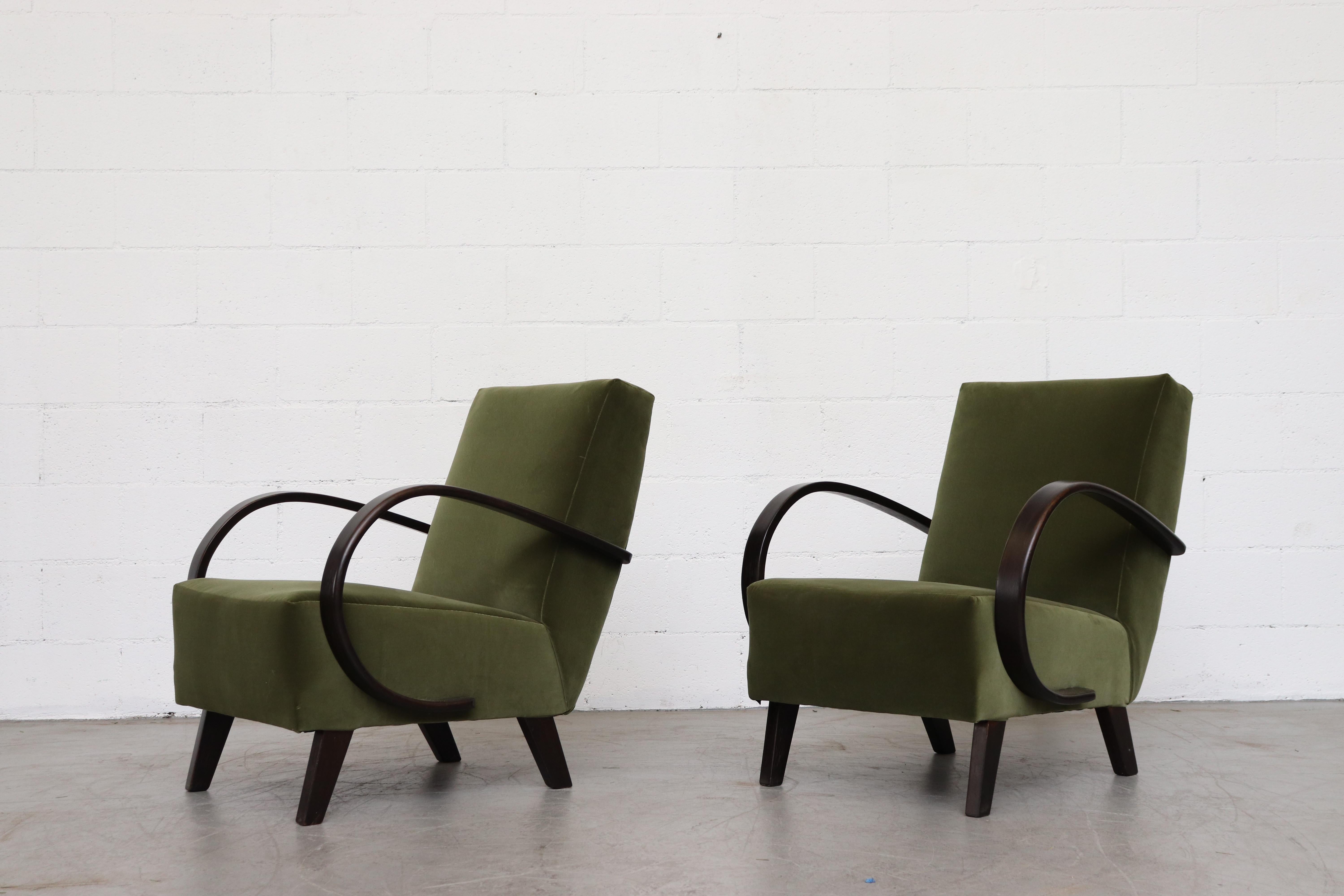 Pair of Jindrich Halabala attributed for UP Závody. Beautiful olive velvet lounge chairs with dark stained bentwood arms. Newly upholstered in olive green velvet. Frame has been lightly refinished. In original condition with a beautiful patina and