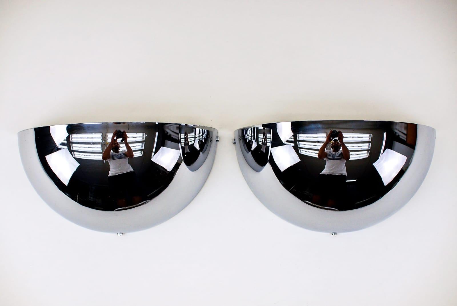 Pair of half round space age chrome wall lamps by LEOLA, 1970s Germany.

Very elegant.

Fully functional.

Each E27 socket. Works with 220V and 110V.

Wiring is suitable for all countries.