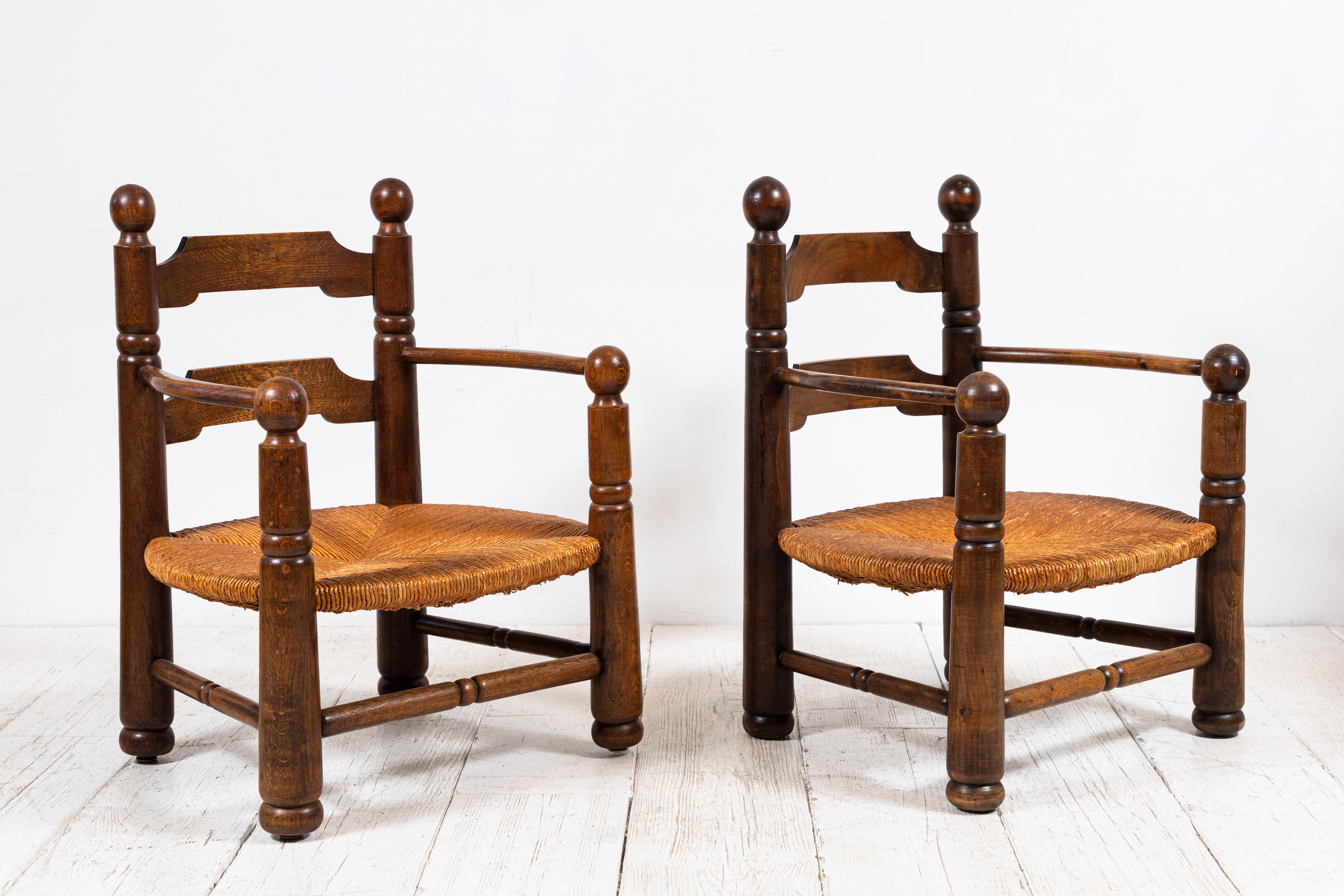 Pair of Hamam armchairs with rush seats and ball finial details.